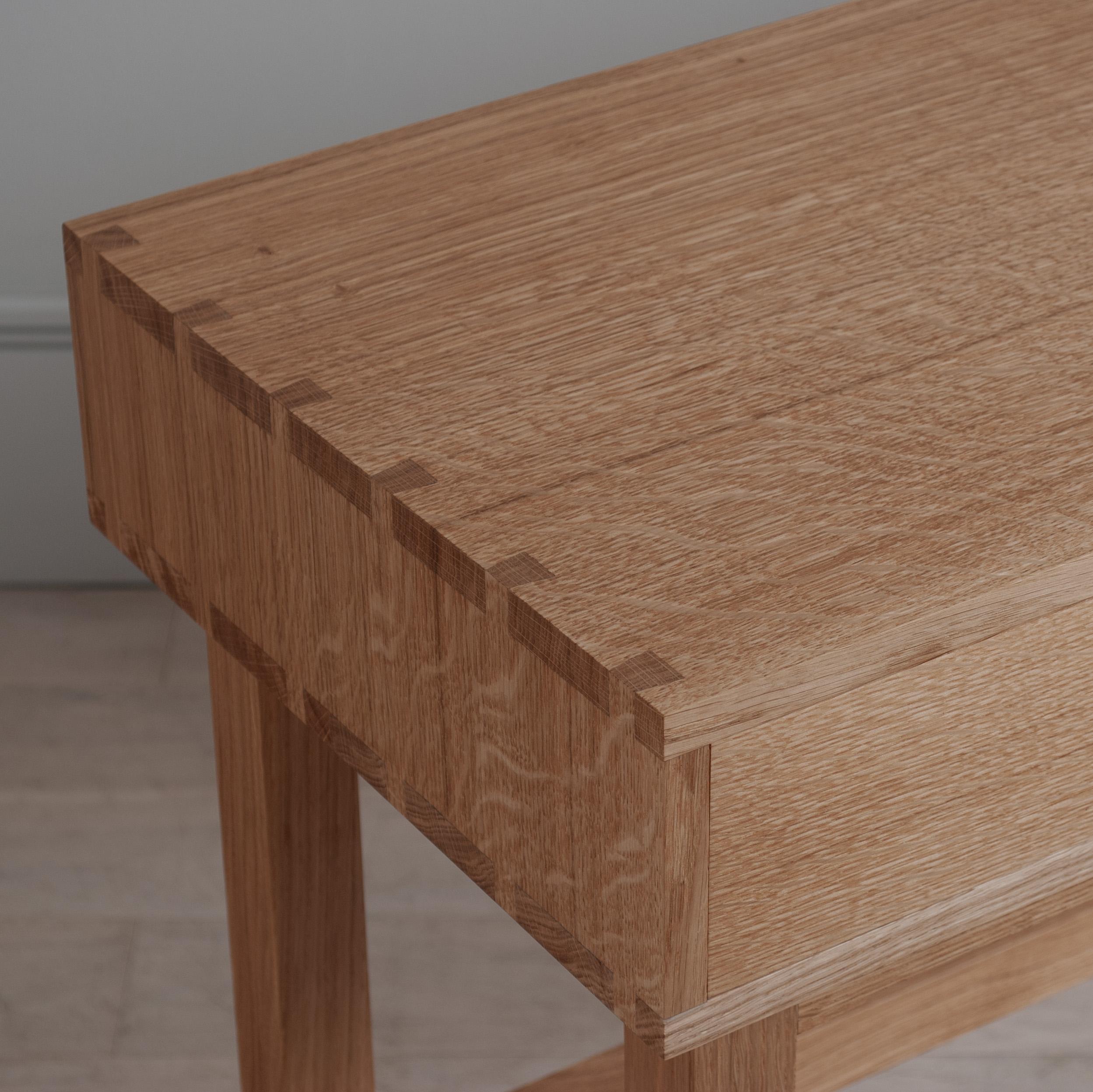 A large handcrafted English oak 2 drawer console table. Designed and handmade in England using skilled traditional furniture making techniques. Completely handcrafted from the finest fully quarter-sawn English oak. Hand dovetailed construction
