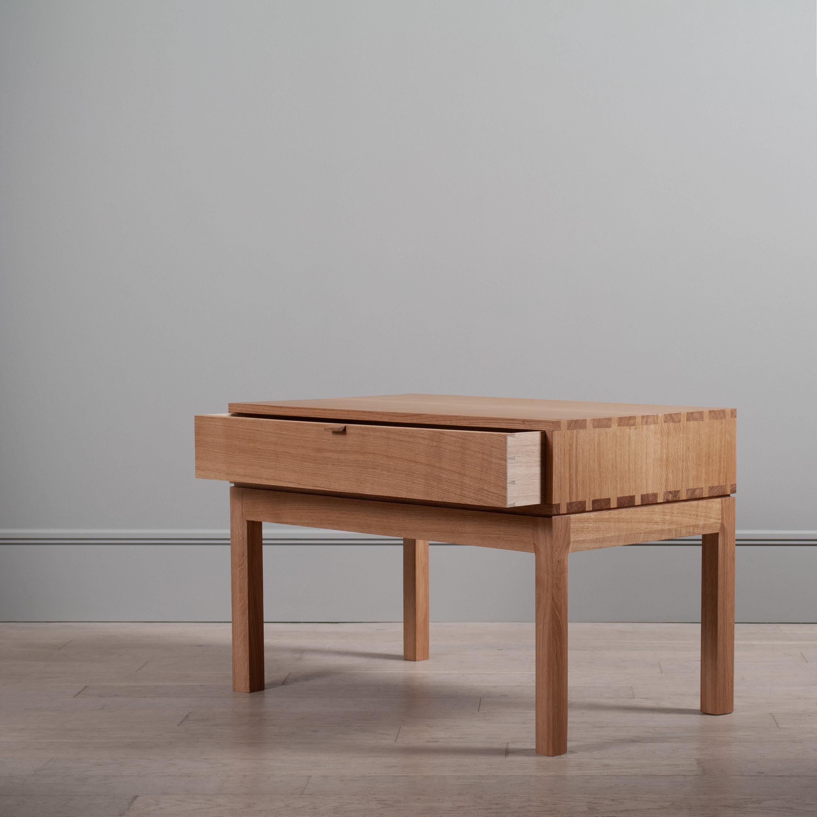 A variation, in much larger proportions, of our handcrafted modernist nightstands or end tables. The main upper box is detailed with exposed hand-cut dovetail jointing and contains one spacious traditional dovetail jointed drawer. A light curve
