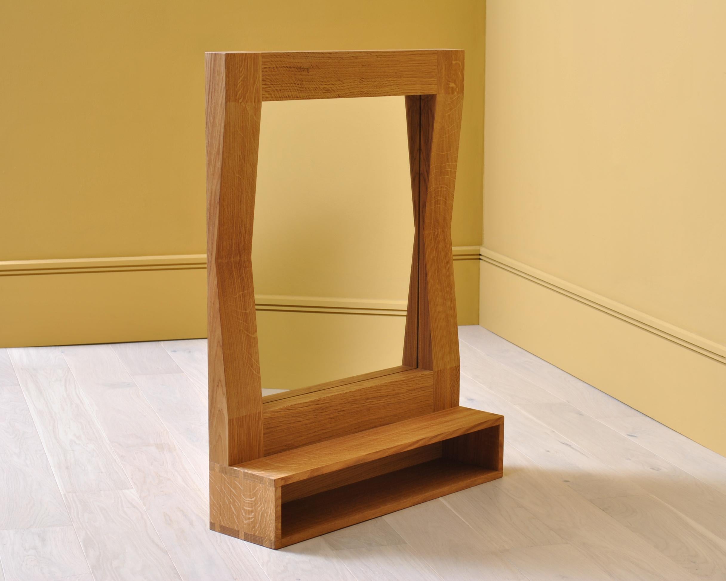Large handcrafted ‘furrow’ oak framed mirror with shelf. Designed by SUM furniture and handcrafted in finest fully quartersawn English oak. Hand finished in natural oils. The furrow mirror creates a striking presence and gives the illusion of it