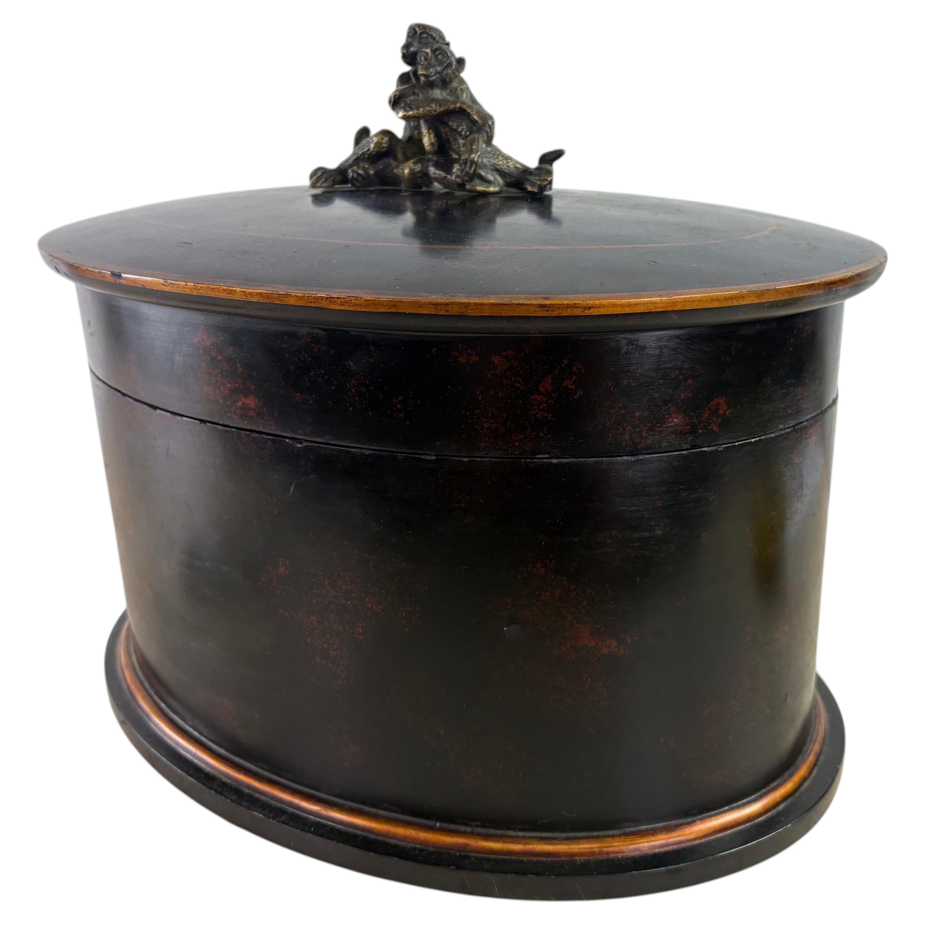 Large handcrafted oval dresser box with bronze monkeys handle For Sale