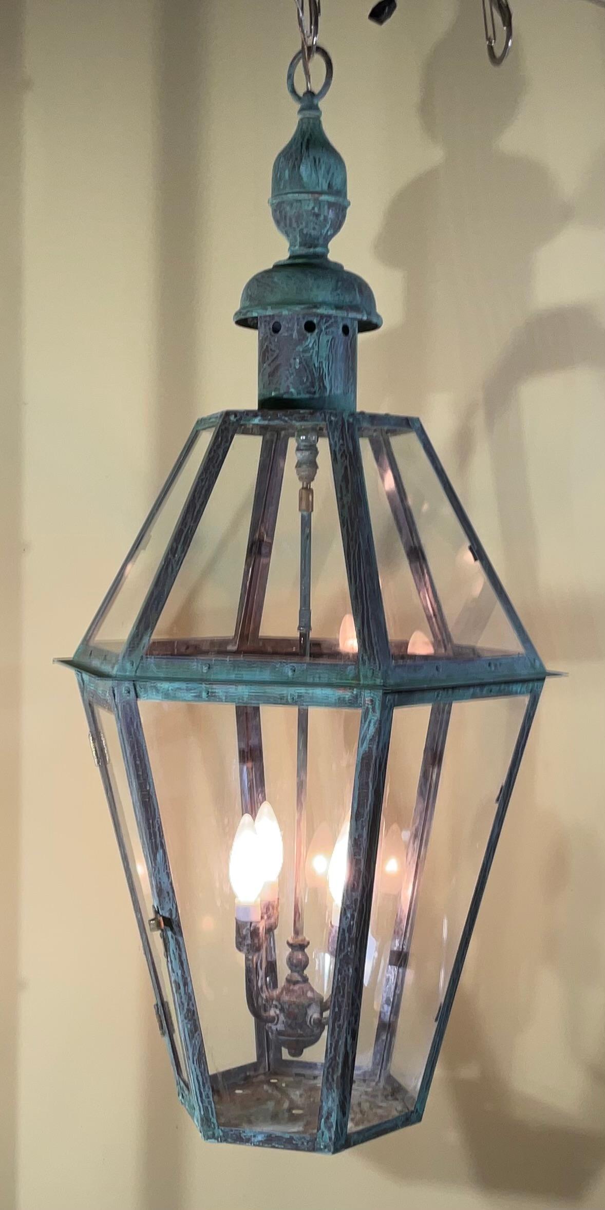 One of a kind 
Exceptional six side hanging lantern ,made of handcrafted solid copper and brass stem with four 60/watt lights, great light exposure,nice patina ,suitable for wet location
great look indoor outdoor.
Copper canopy and chain included.