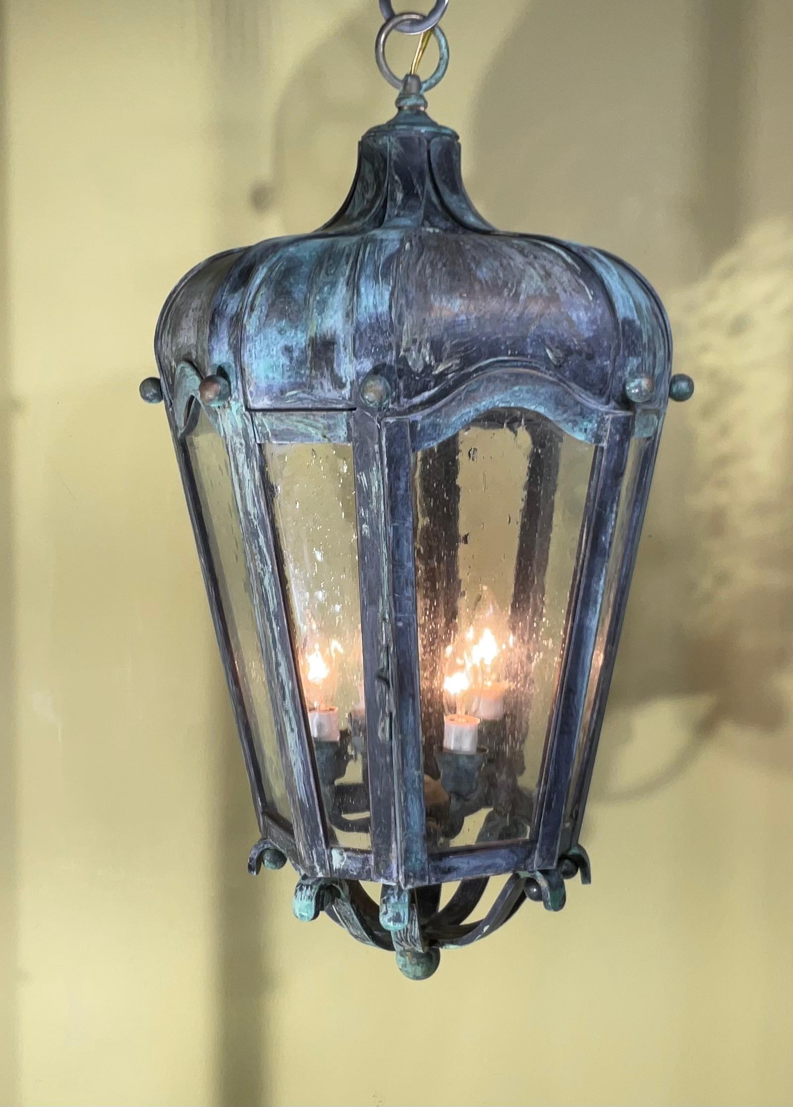 
Elegant hanging lantern  ,quality made of handcrafted solid brass with four 40/watt lights, decorative seeded glass ,great light exposure , nice patina ,suitable for wet location
great look indoor outdoor.
canopy and chain included.