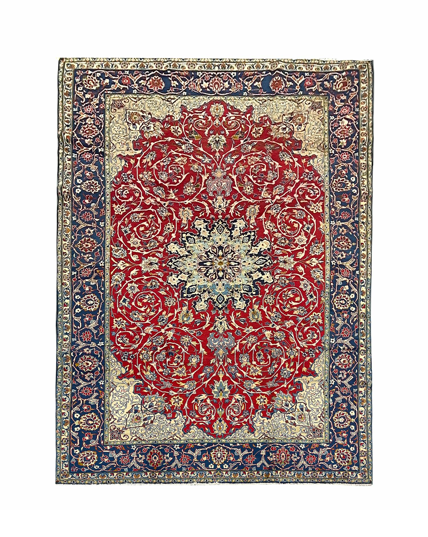 This elegant, rich red rug features a highly-detailed all over and surrounding design. It is decorated with a beautiful array of floral motifs woven symmetrically to create a decorative masterpiece. The enclosing border is woven on a contrasting