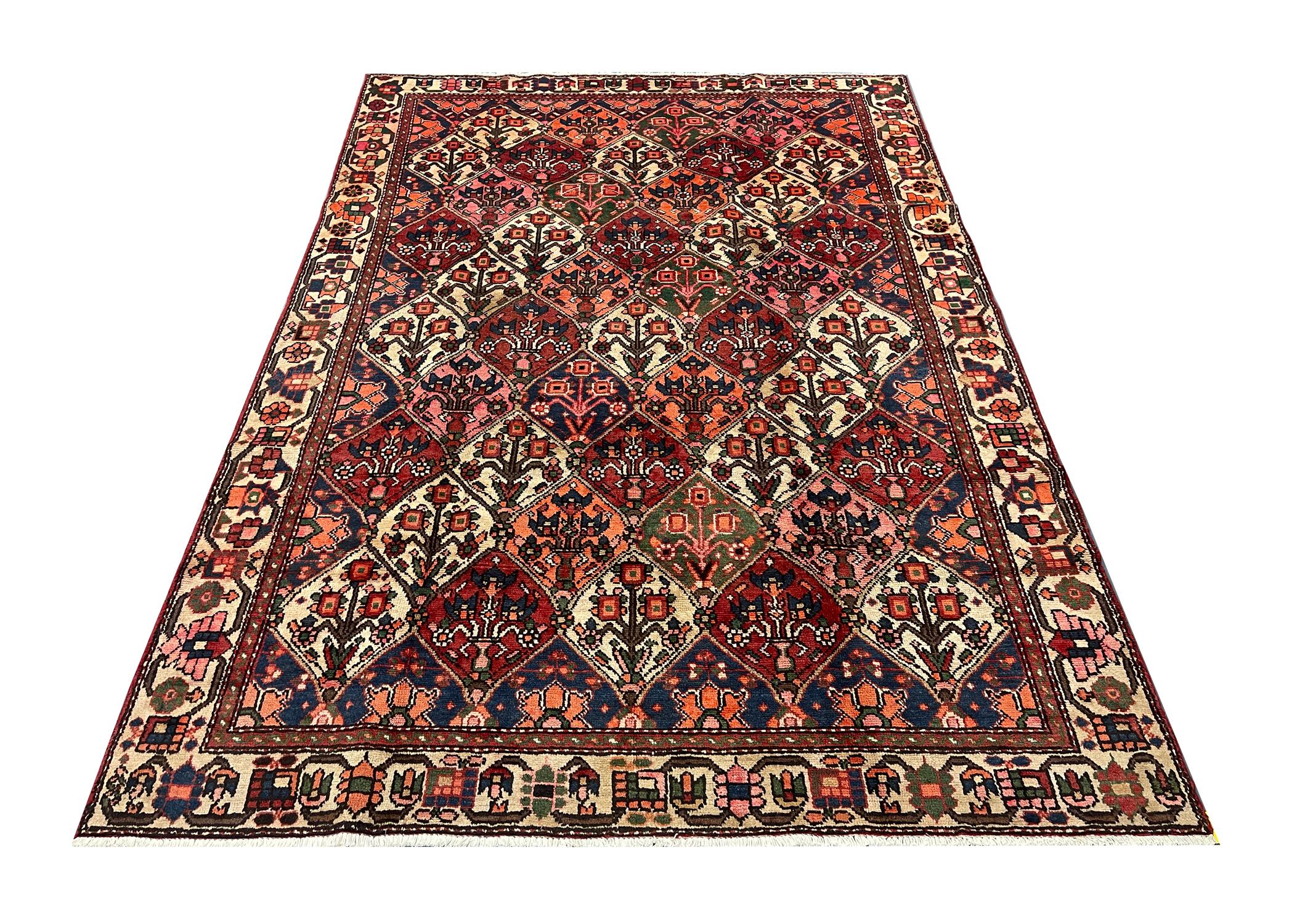 This elegant, rich red rug features a highly-detailed all over and surrounding design. It is decorated with a beautiful array of floral motifs woven symmetrically to create a decorative masterpiece. The enclosing border is woven on a contrasting