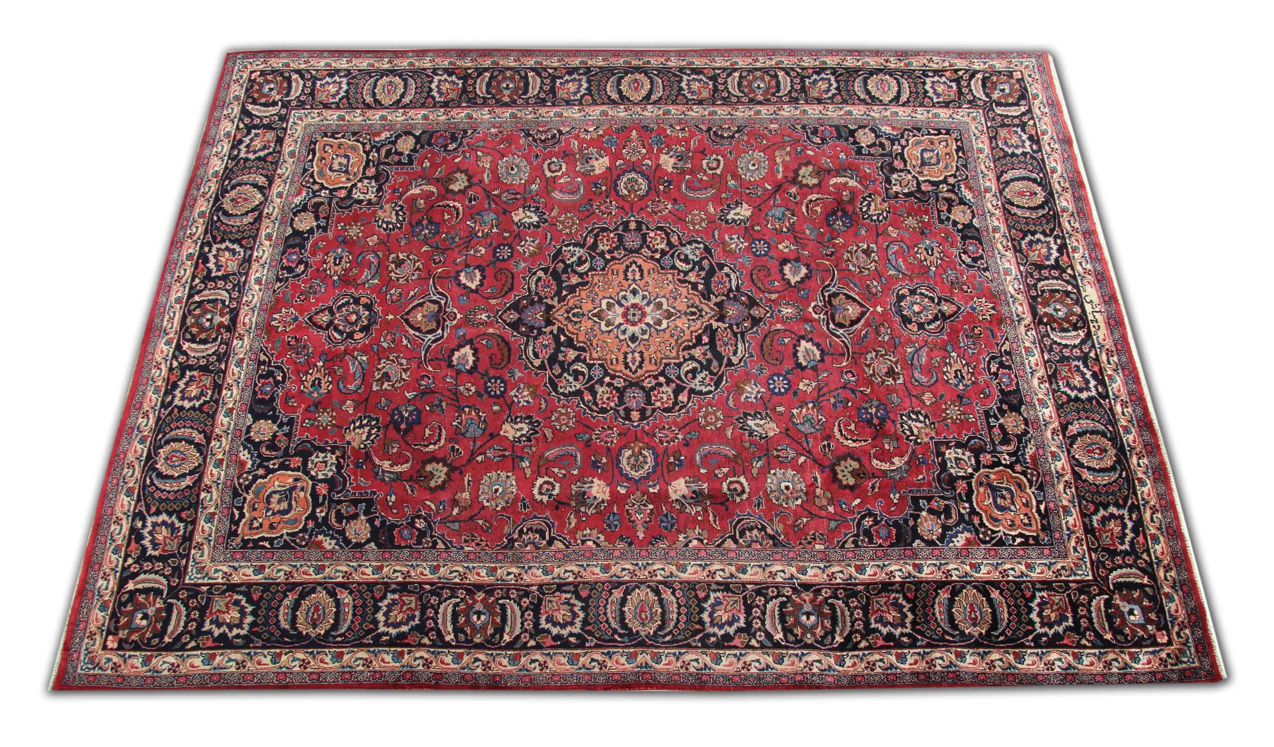 This elegant, rich red rug features a highly-detailed central medallion and surrounding design. It is decorated with a beautiful array of floral motifs woven symmetrically to create a decorative masterpiece. The enclosing border is woven on a