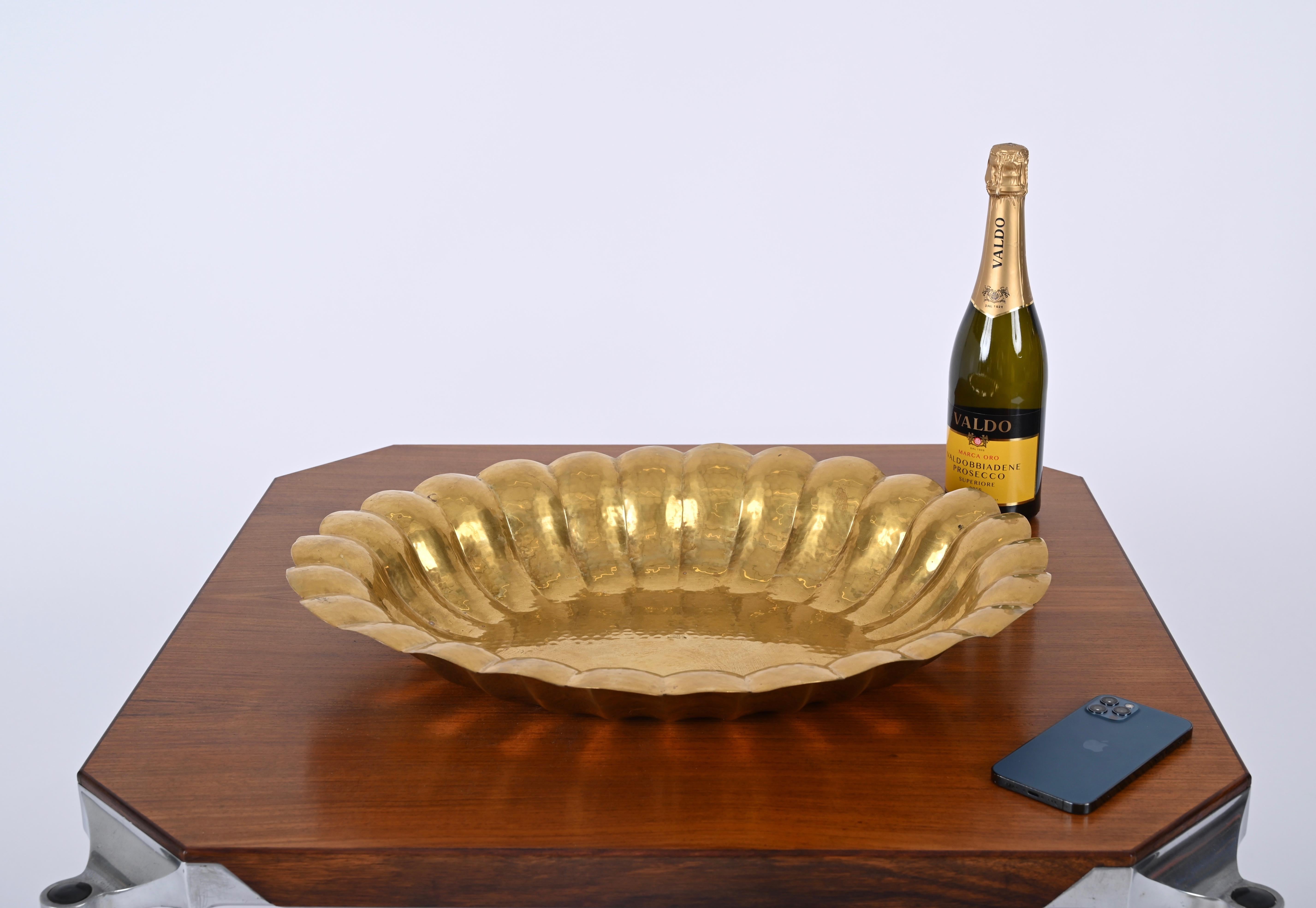 Fantastic large oval centerpiece fully hand-made in hammered brass. This gorgeous object was designed by Renzo Cassetti in Italy during the 1970ss and is engraved on the back by Cassetti. 

The unique feature of this embossed centerpiece, as you can