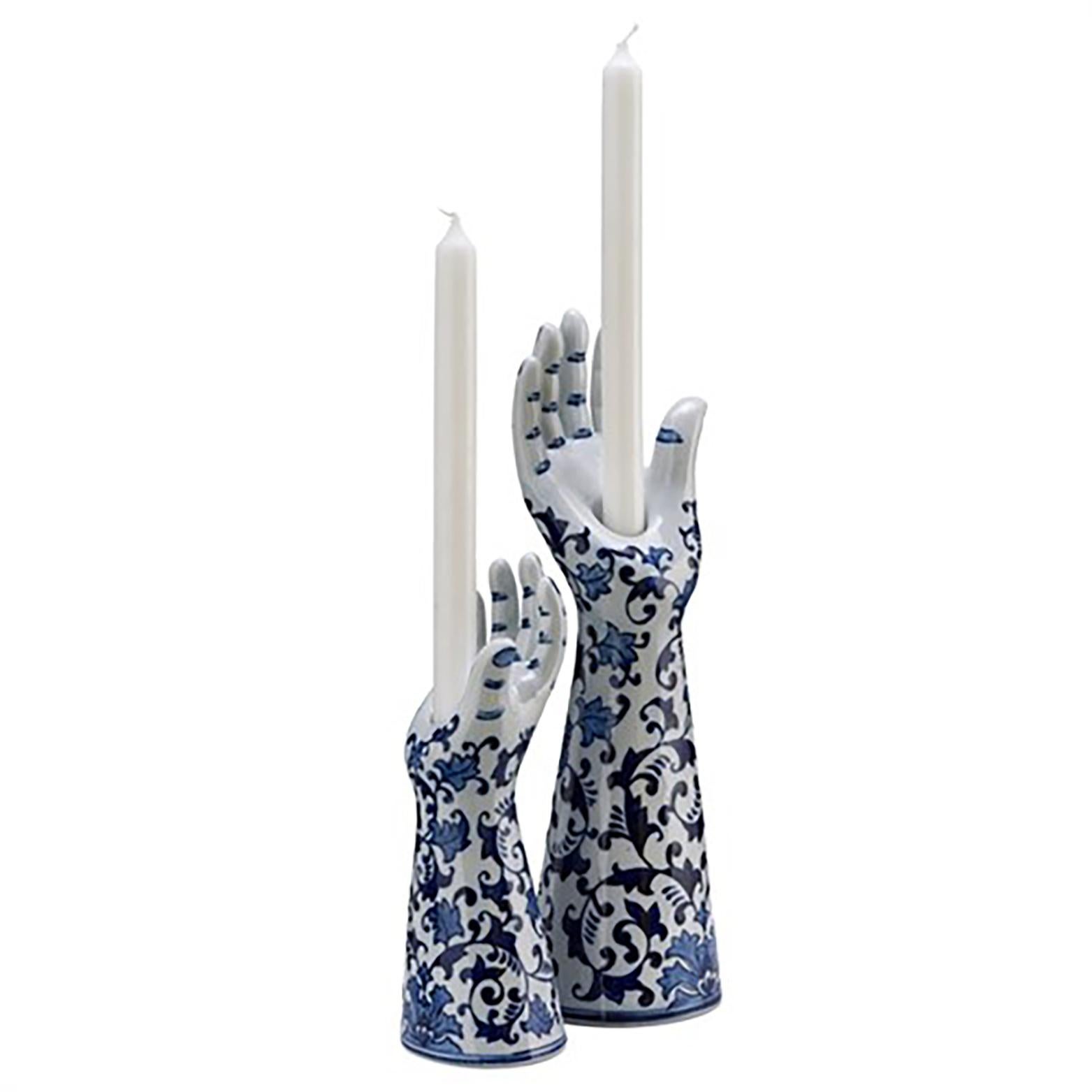 A candleholder in the shape of a human hand. This unique accessory is porcelain made with a glazed finish. A hand painted blue floral pattern wraps around the exterior. Holds one tapered candle. Crafted in the Netherlands.

Measurements:

15” H