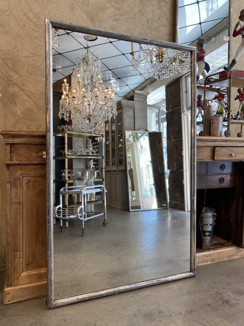 Large and handsome antique rectangular mirror, from France circa1880-1890. A sleek and charming rounded silver frame with delightful authentic patina. The mirror still has the original fine silver leaf coating on the frame and the old mercury mirror