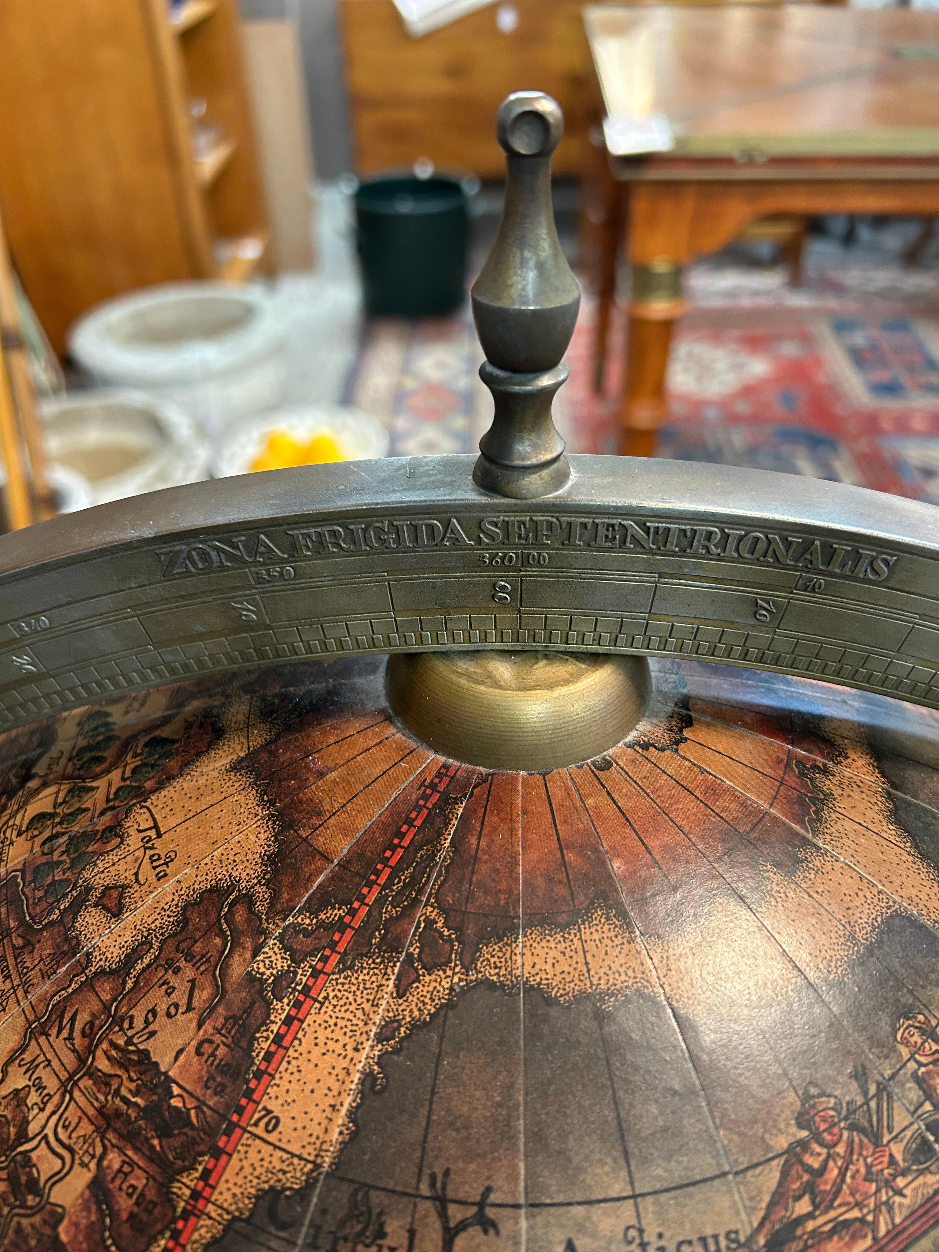 Vintage large globe that opens to a liquor cabinet dry bar inside with places for bottles, glasses and ice.  Handsomely decorated in antique style world map incorporating zodiac signs and astrological illustrations.
