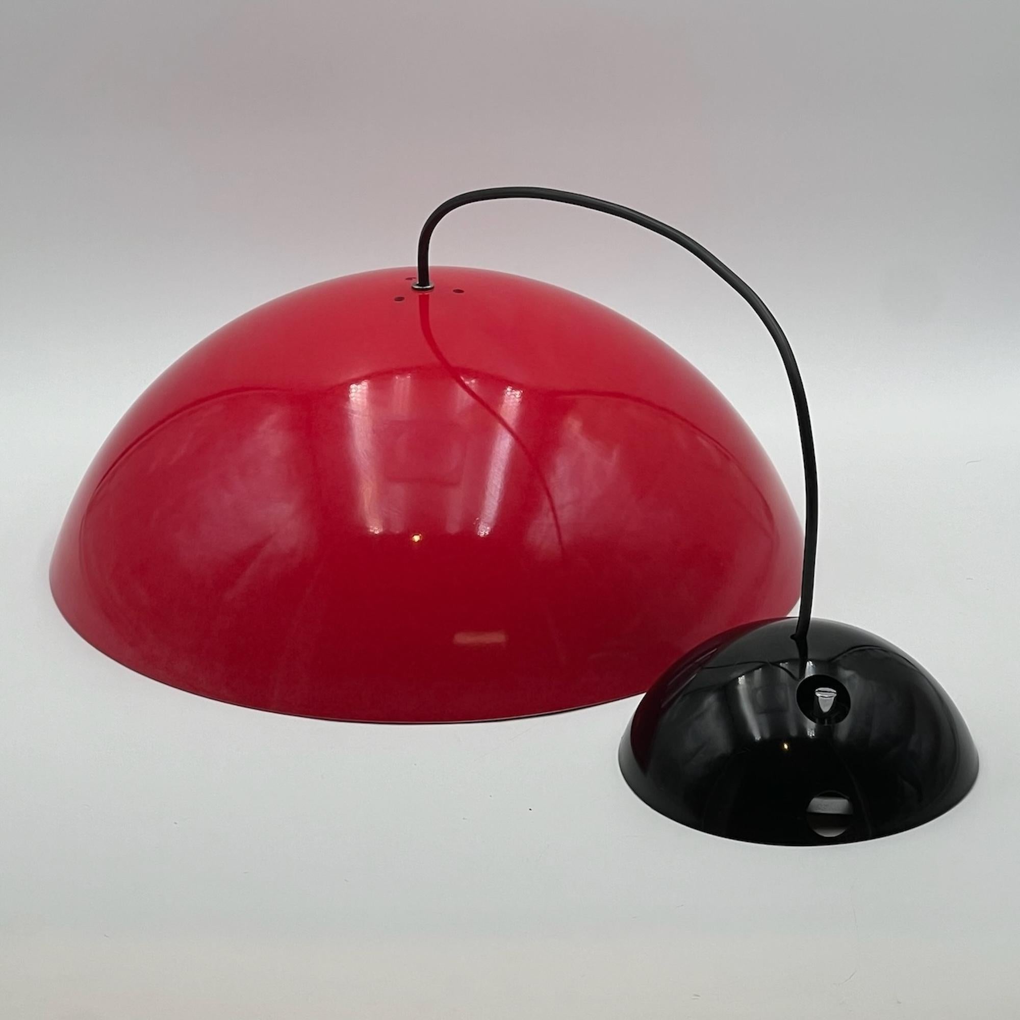 Embark on a journey through vintage design with the 'Coupe' Big Hanging Lamp by Elio Martinelli, a true gem crafted by Martinelli Luce in Italy during the 1970s. This oversized vintage lamp boasts a distinctive rounded lampshade in glossy red ABS,