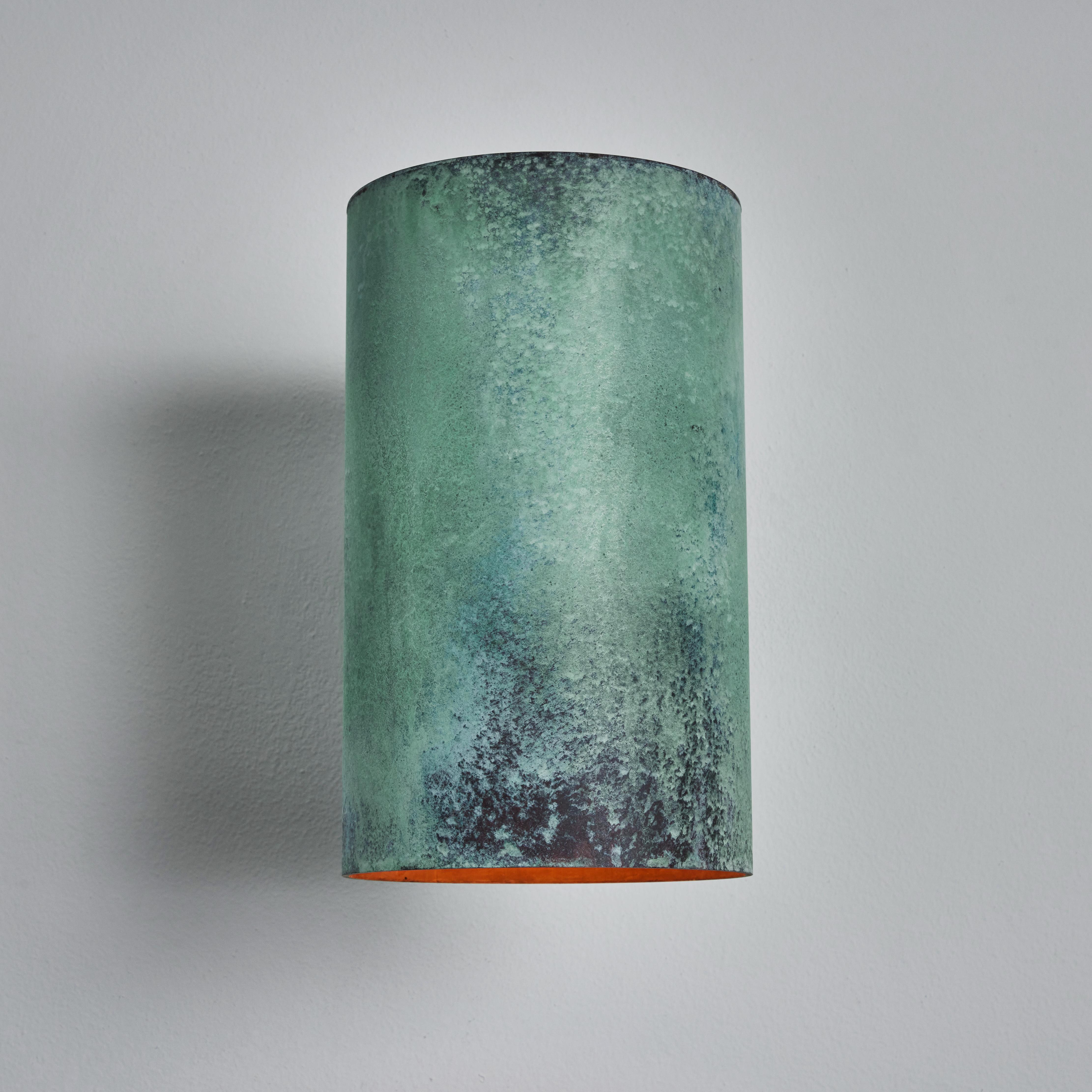 Large Hans-Agne Jakobsson C 627 'Rulle' verdigris patinated sconce. An exclusive made for U.S. and UL listed authorized re-edition of the classic Swedish design executed in richly patinated metal with raw unlacquered metal interior that will