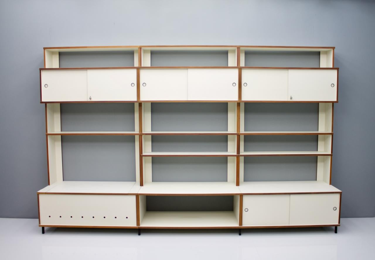 Rare and large shelf system with sideboards and shelves from the furniture system M125 by Hans Gugelot for Bofinger, Germany, 1956.
The cabinets have sliding doors, two have locks with key, one element has a flap up to store.


The system can be