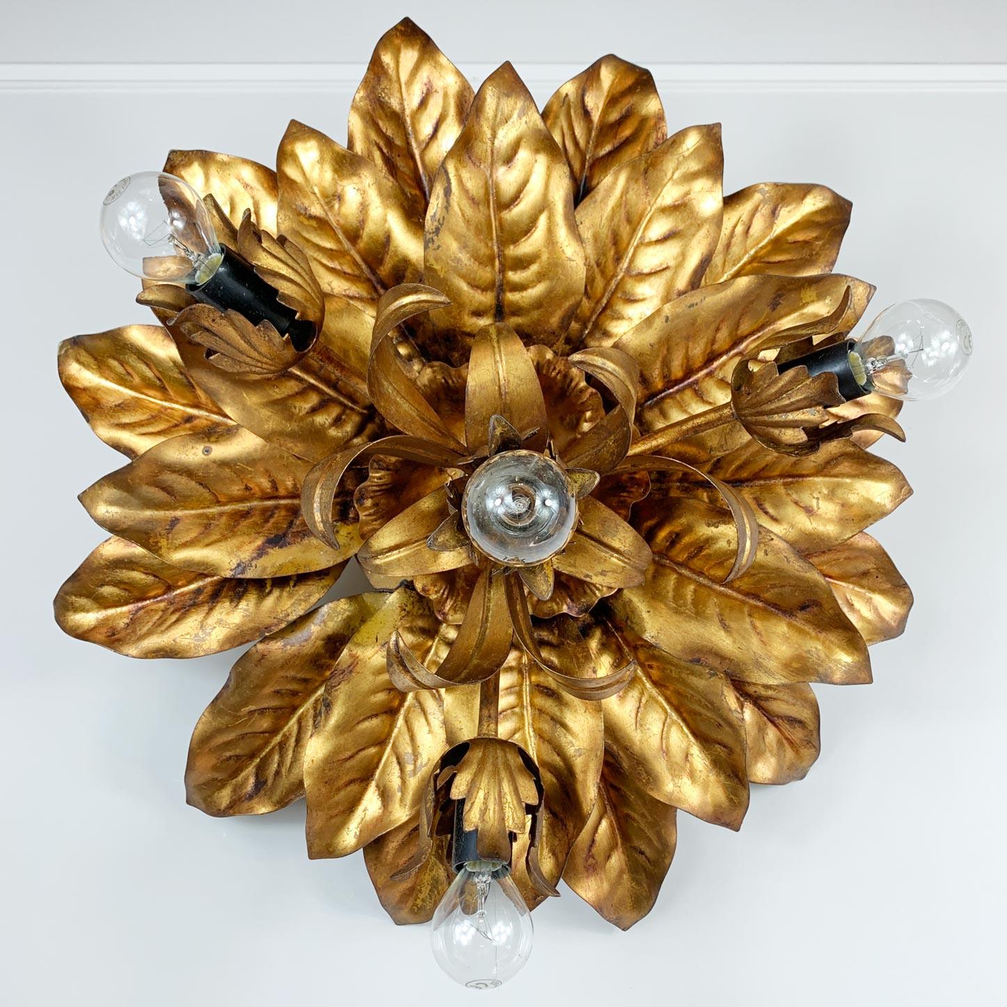 A beautifully crafted 1970’s flush mount ceiling light by Hans Kogl, the design is an abundance of gilt floral petals and leaves. 

The four lamp holders to the centre and sides each take an e14 (small screw in) bulb, another exceptionally well