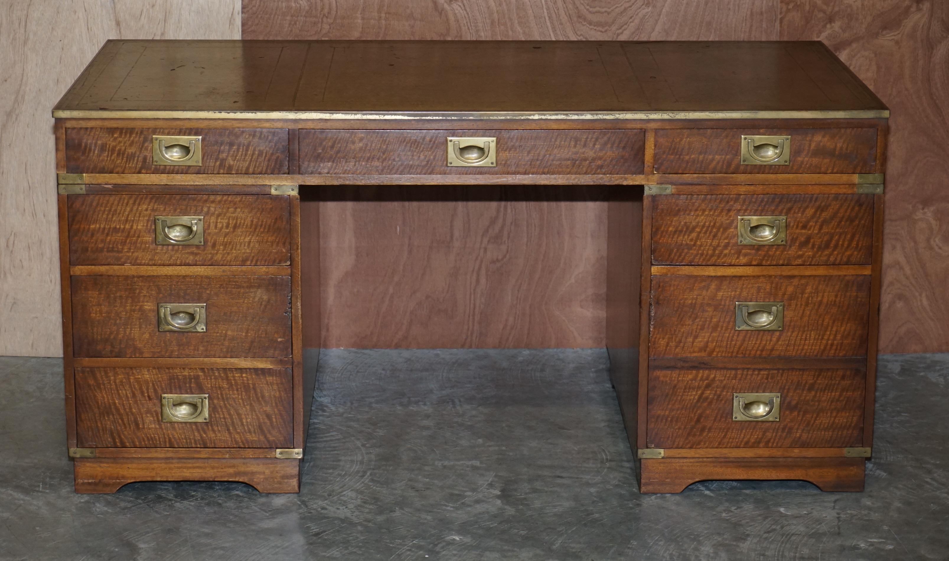 We are delighted to offer for sale this lovely hand made in England Harrods Kennedy Military Campaign twin pedestal partner desk green leather writing surface

This desk is made in the military campaign style with recessed handles and brass trip.