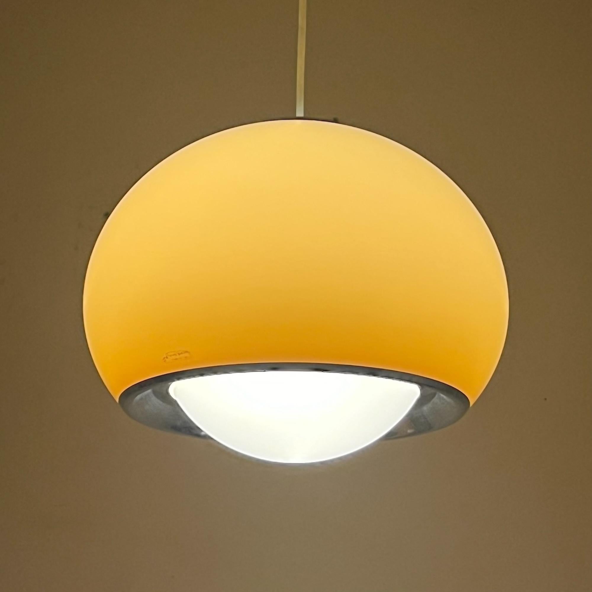 Step back into the vibrant Seventies with the stunning 70s Lamp Model Bud 3029, designed by Studio 6G, the internal design team of Harvey Guzzini, in 1968. This remarkable piece, manufactured by Harvey Guzzini/iGuzzini in Recanati, Italy, is a