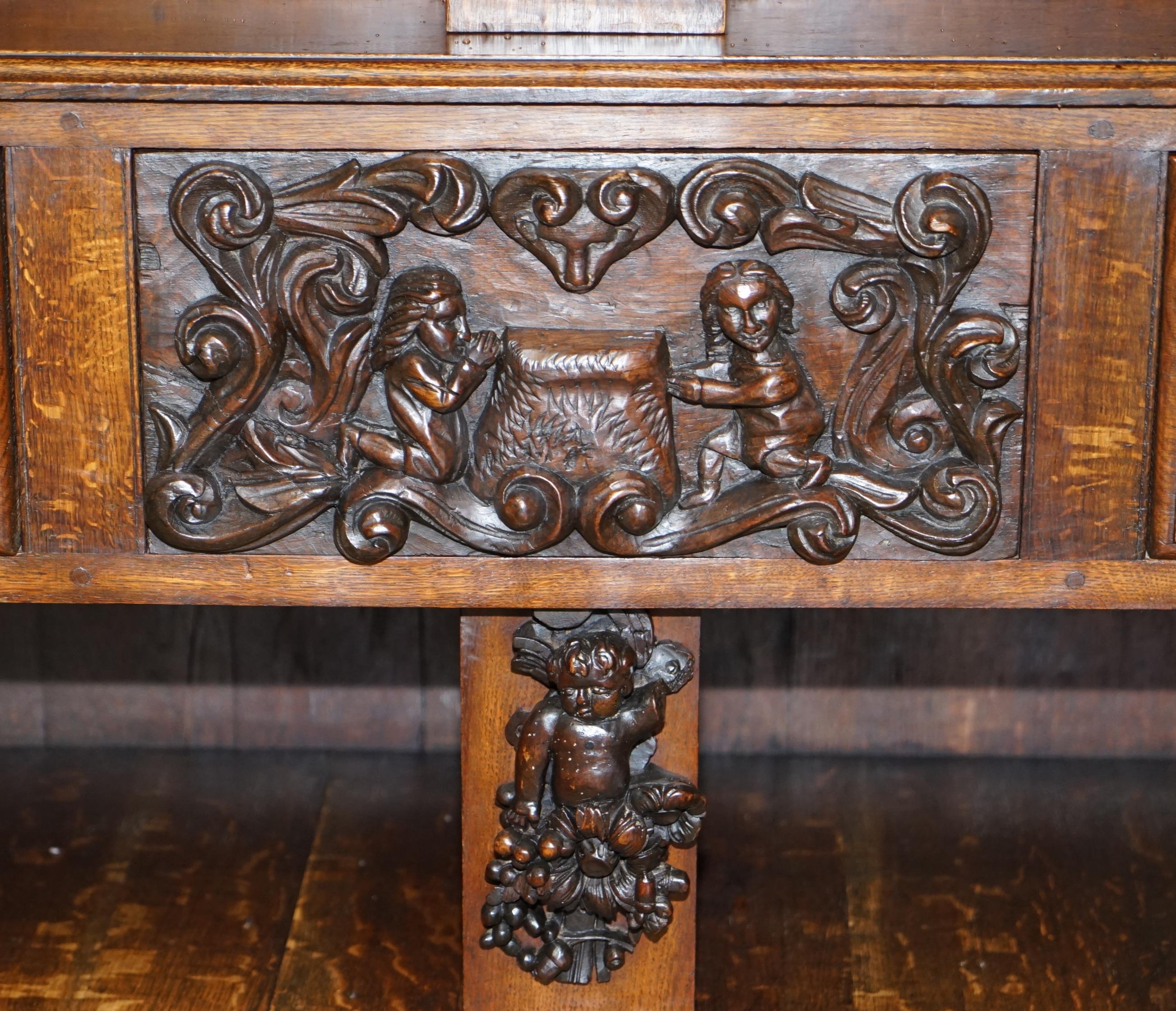Oak Large Heavily Carved Bookcase Cupboard with Ornate Cherub Putti & Lion Figures For Sale