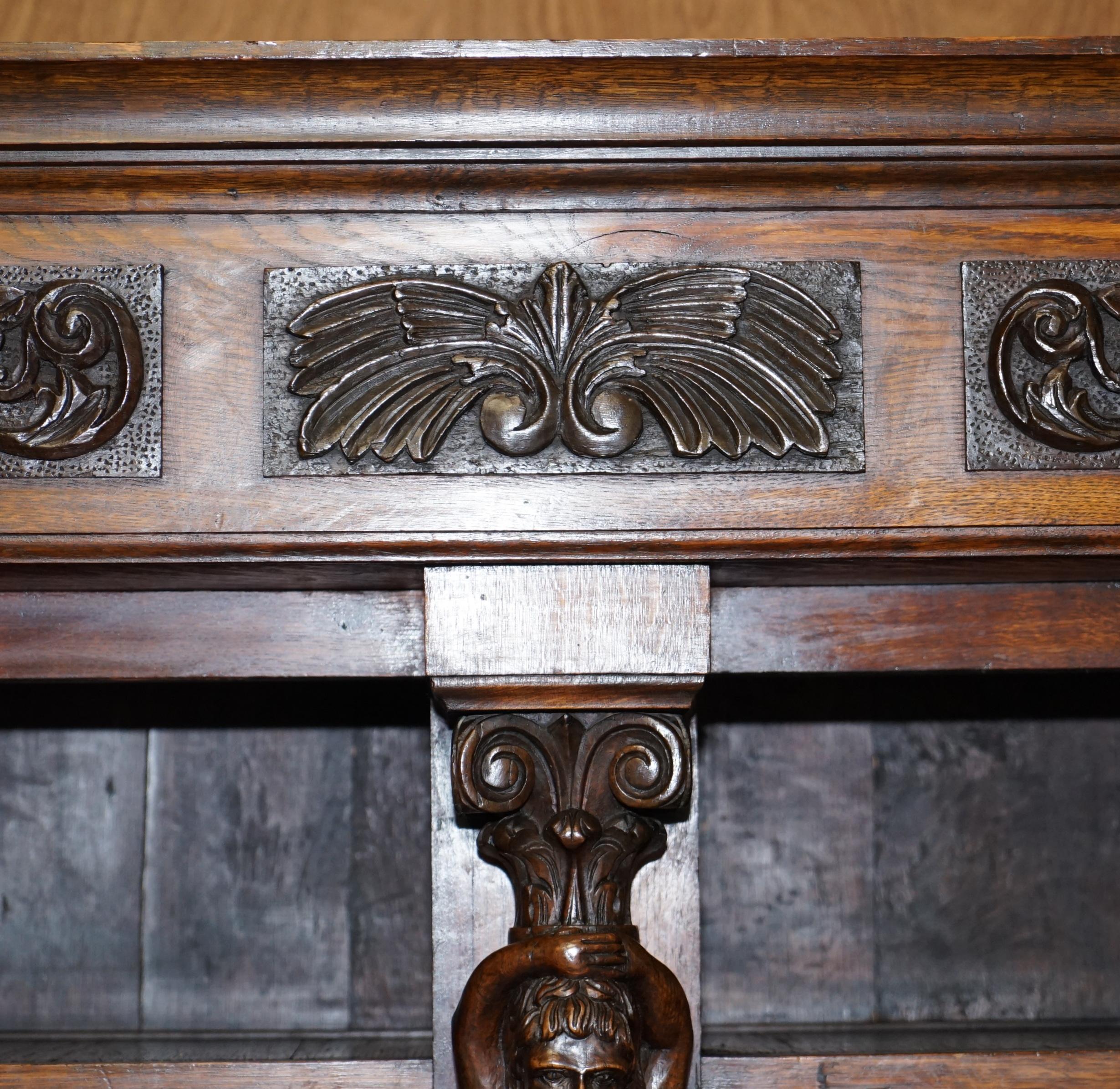 Late 19th Century Large Heavily Carved Bookcase Cupboard with Ornate Cherub Putti & Lion Figures For Sale