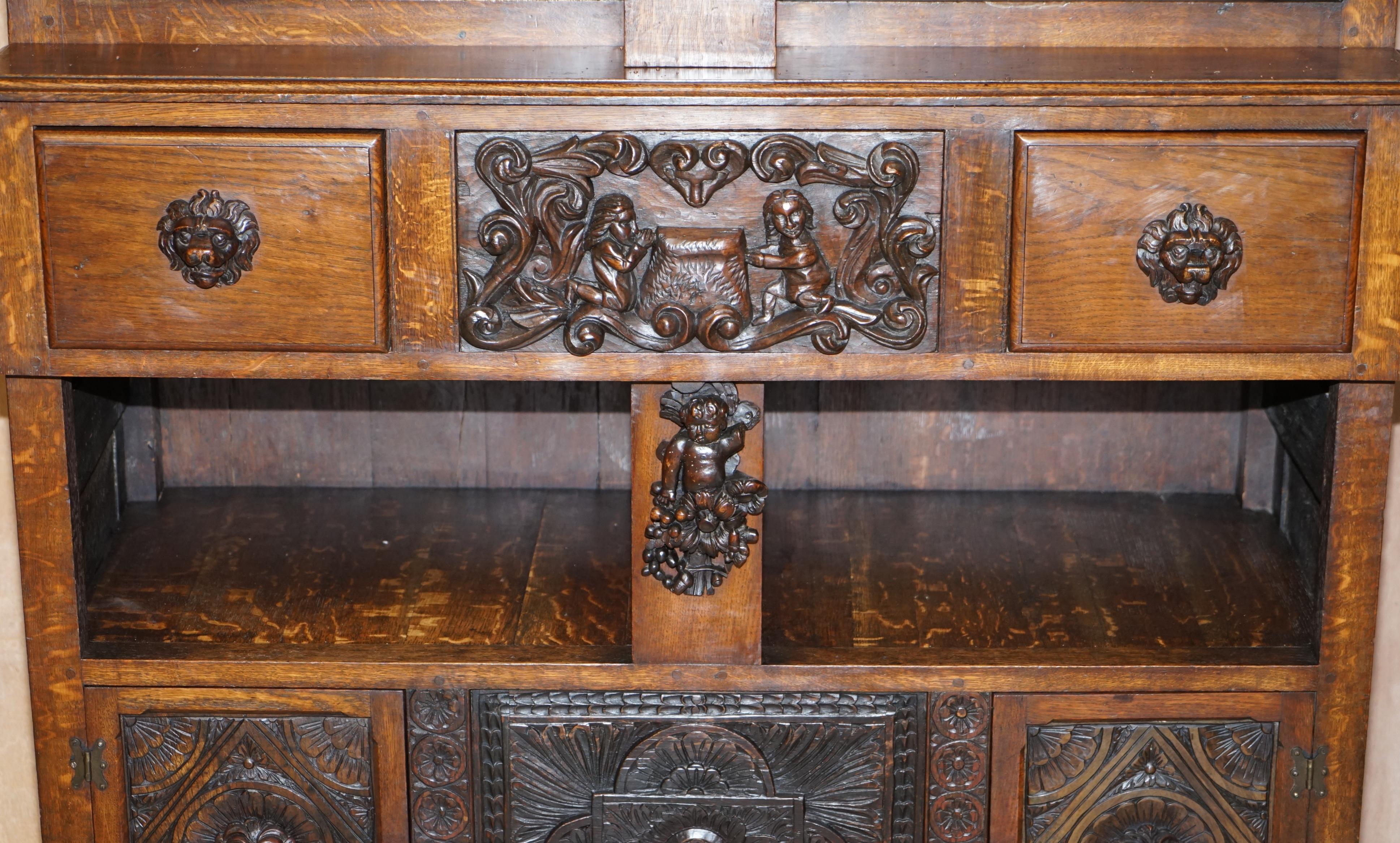 Oak Large Heavily Carved Bookcase Cupboard with Ornate Cherub Putti & Lion Figures For Sale