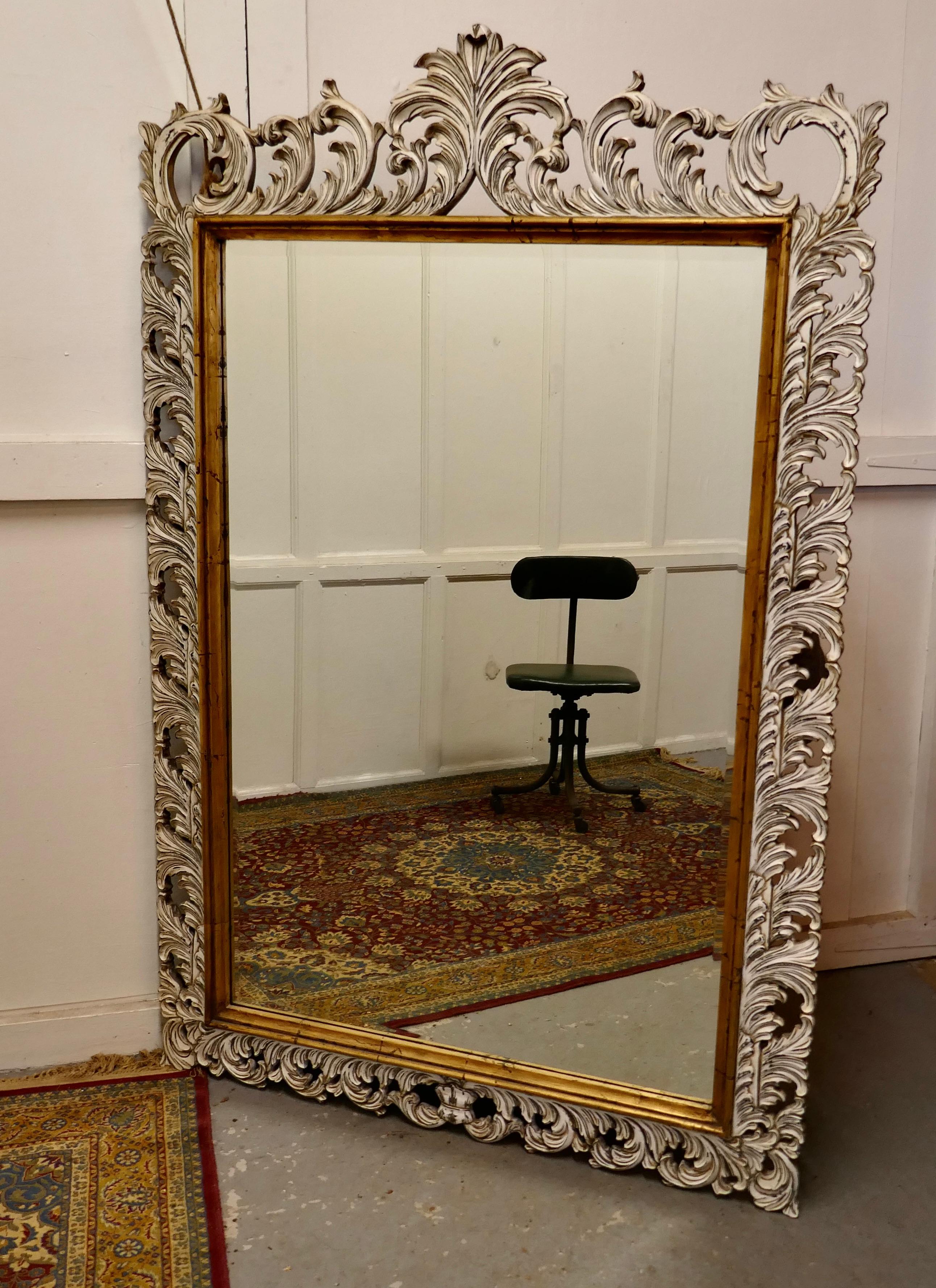 Large heavily carved fruitwood distressed paint mirror

A lovely piece the 6” wide frame is intricately carved with curving acanthus leaves 
The painted surface of the carved wood has been slightly distressed showing the great depth of the