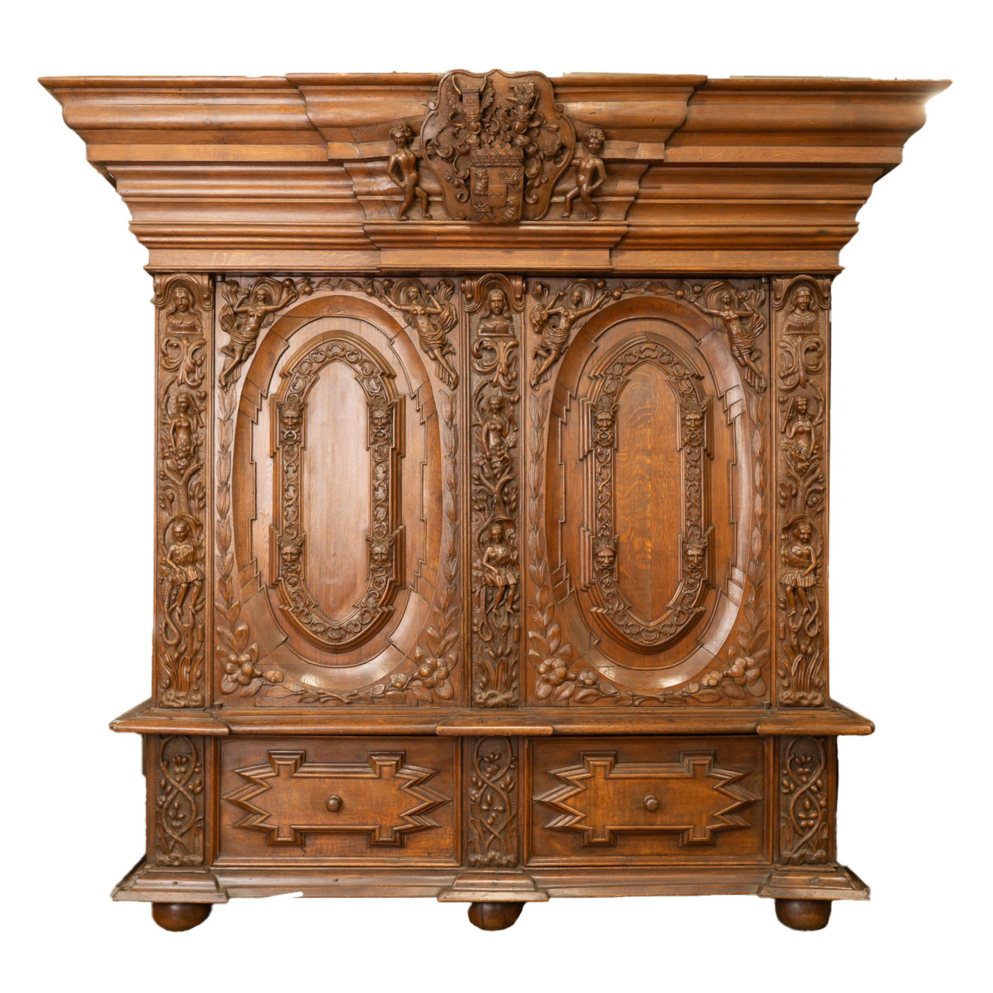 Grandly standing over 8' tall, this stately hand-carved oak armoire makes a regal statement as it originally stood in the castle of the Swedish noble family of Carl Gustaf Wrangel.
Please enlarge photos to appreciate the fine craftsmanship in the