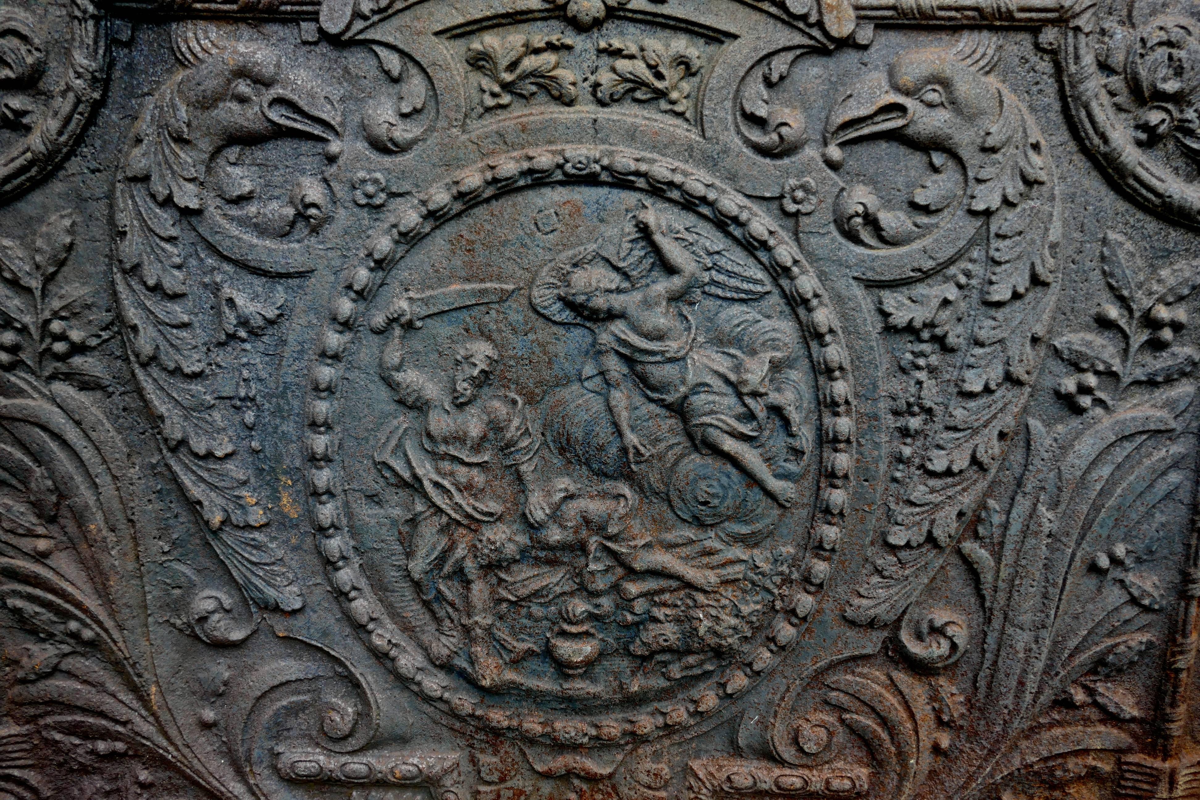 Large heavy 17th century Louis XIV French cast iron fire back 

This is a large and very heavy piece (best estimate 200kgs) the iron has a central scene of Abraham offering the sacrifice of Issac, this scene is set in a roundel and it is flanked
