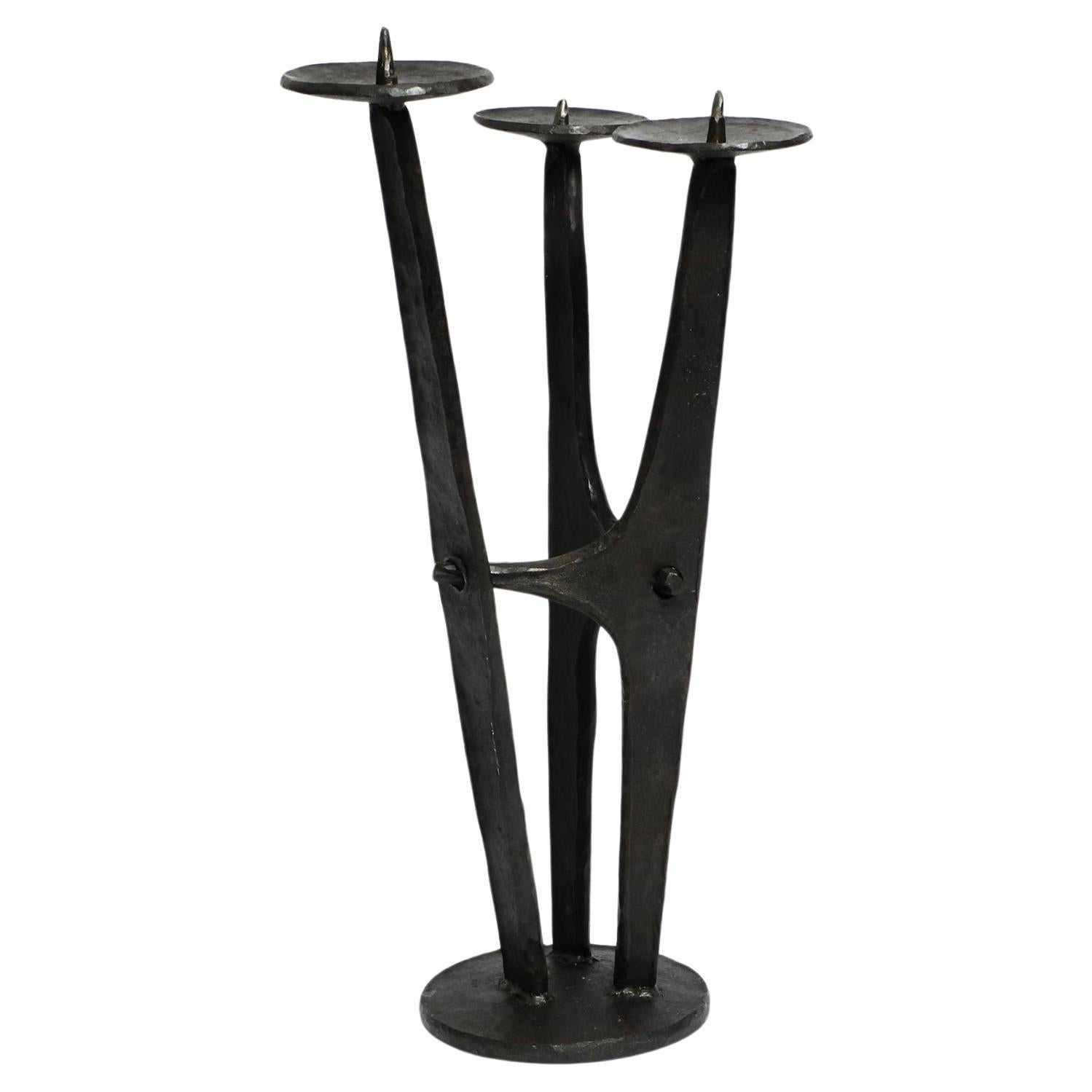 Large, heavy 50s floor candle holder made of wrought iron in Mid Century design For Sale