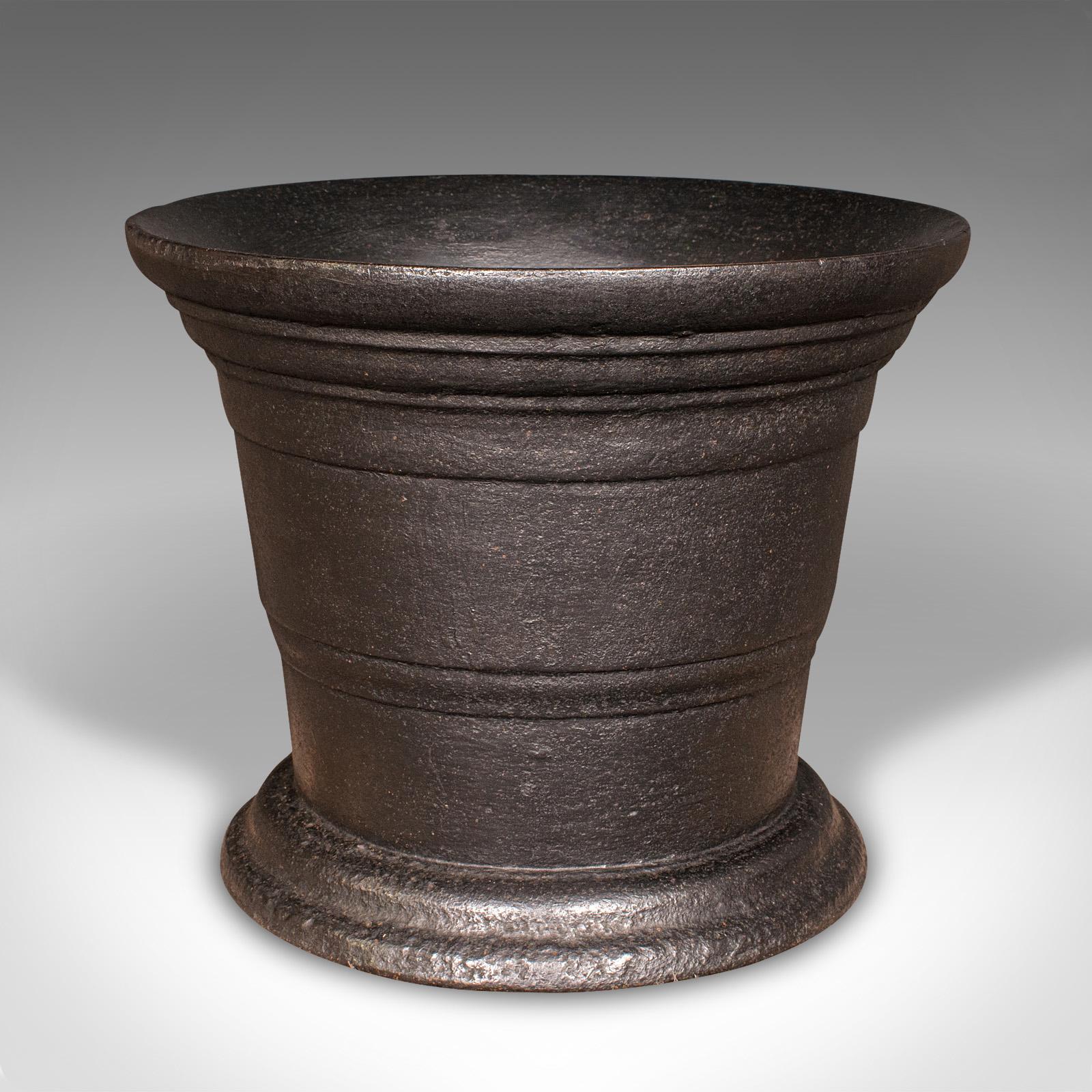 This is a large and heavy antique industrial mortar. An English, cast iron factory fireside bin or basket, dating to the Georgian period, circa 1750.

Exceptionally substantial mortar, versatile within the modern home
Displays a desirable aged
