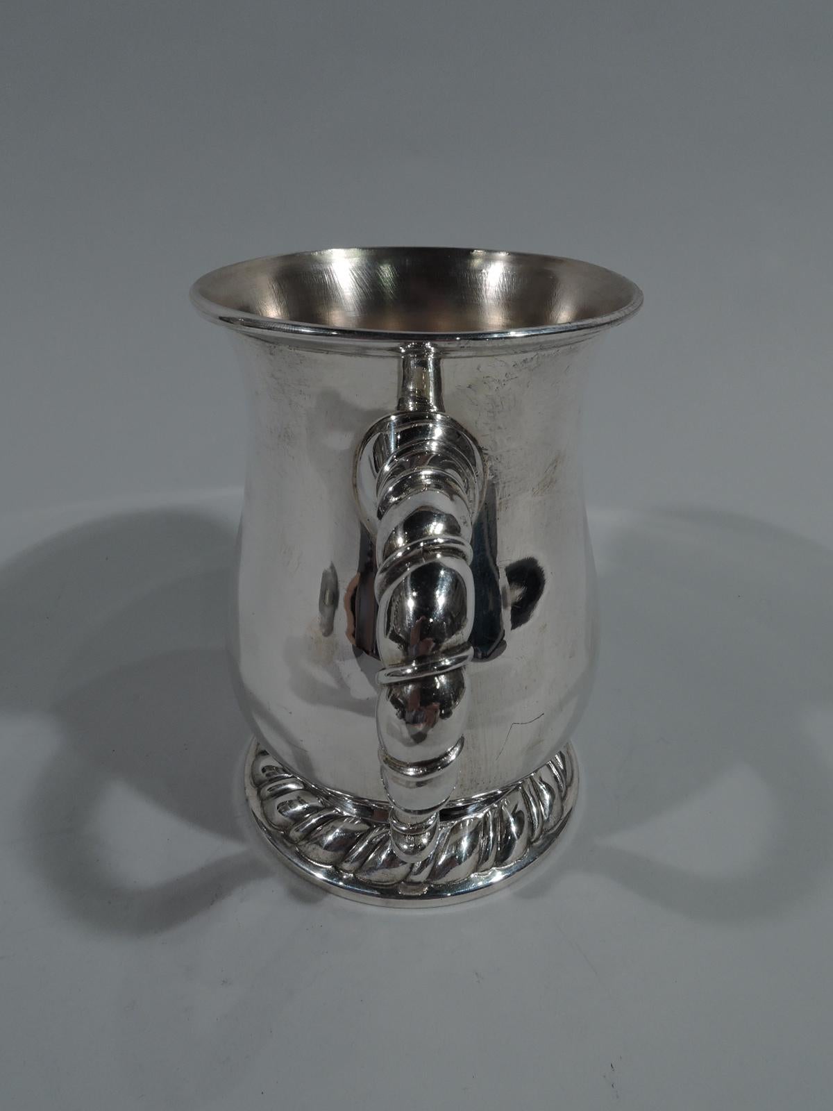 Large and heavy Modern Classical sterling silver christening mug in Torchon pattern. Made by Buccellati in Italy. Baluster on raised and spread foot with embossed gadrooning and scrolled rope handle. Substantial with lots of room for engraving.
