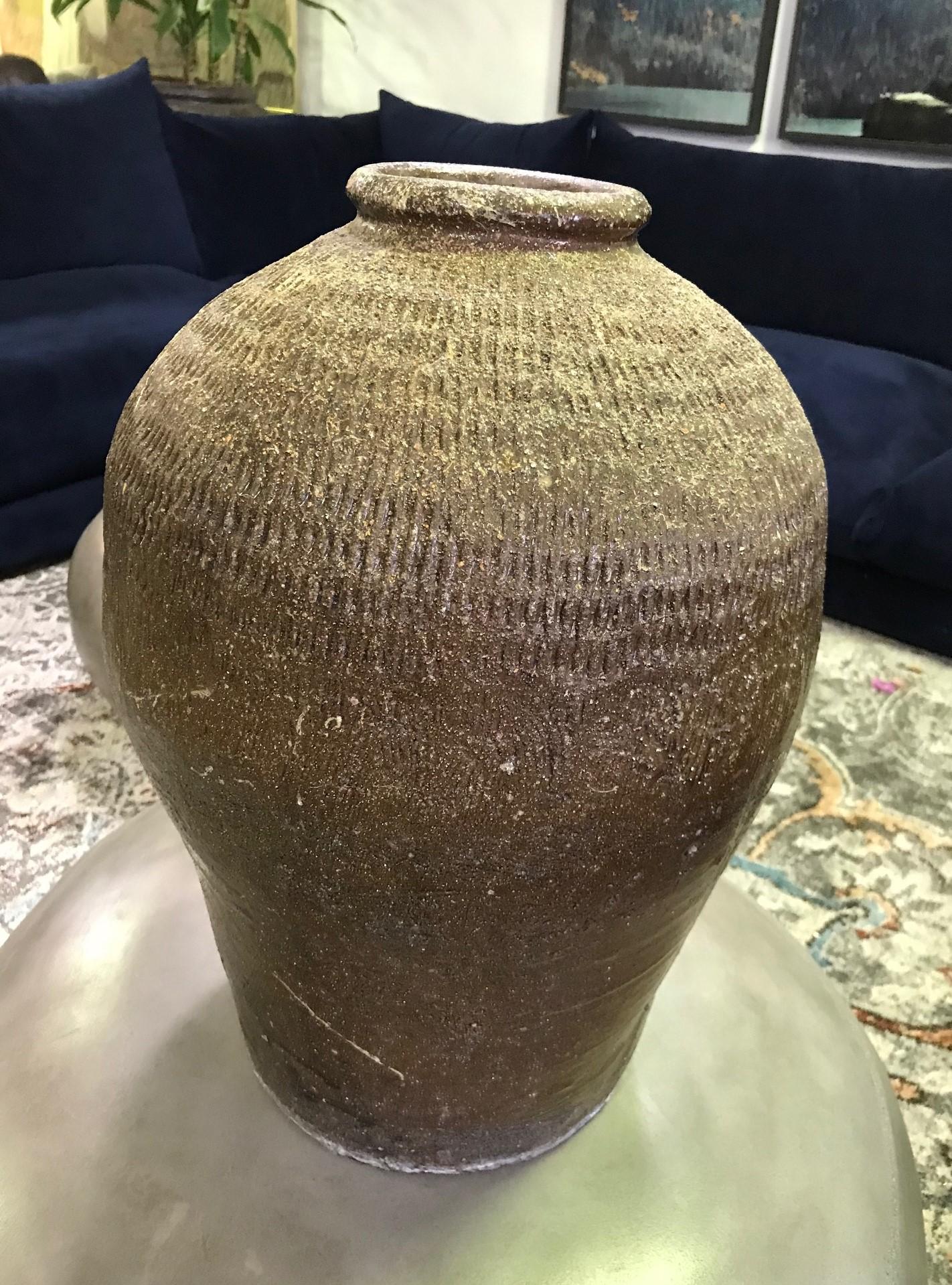 A truly wonderfully made and textured, darkly colored large earthenware vase/jar.

From a group of three vases (please see photos) we acquired from a high-end Southern California estate.

Would clearly stand out in about any setting indoors or