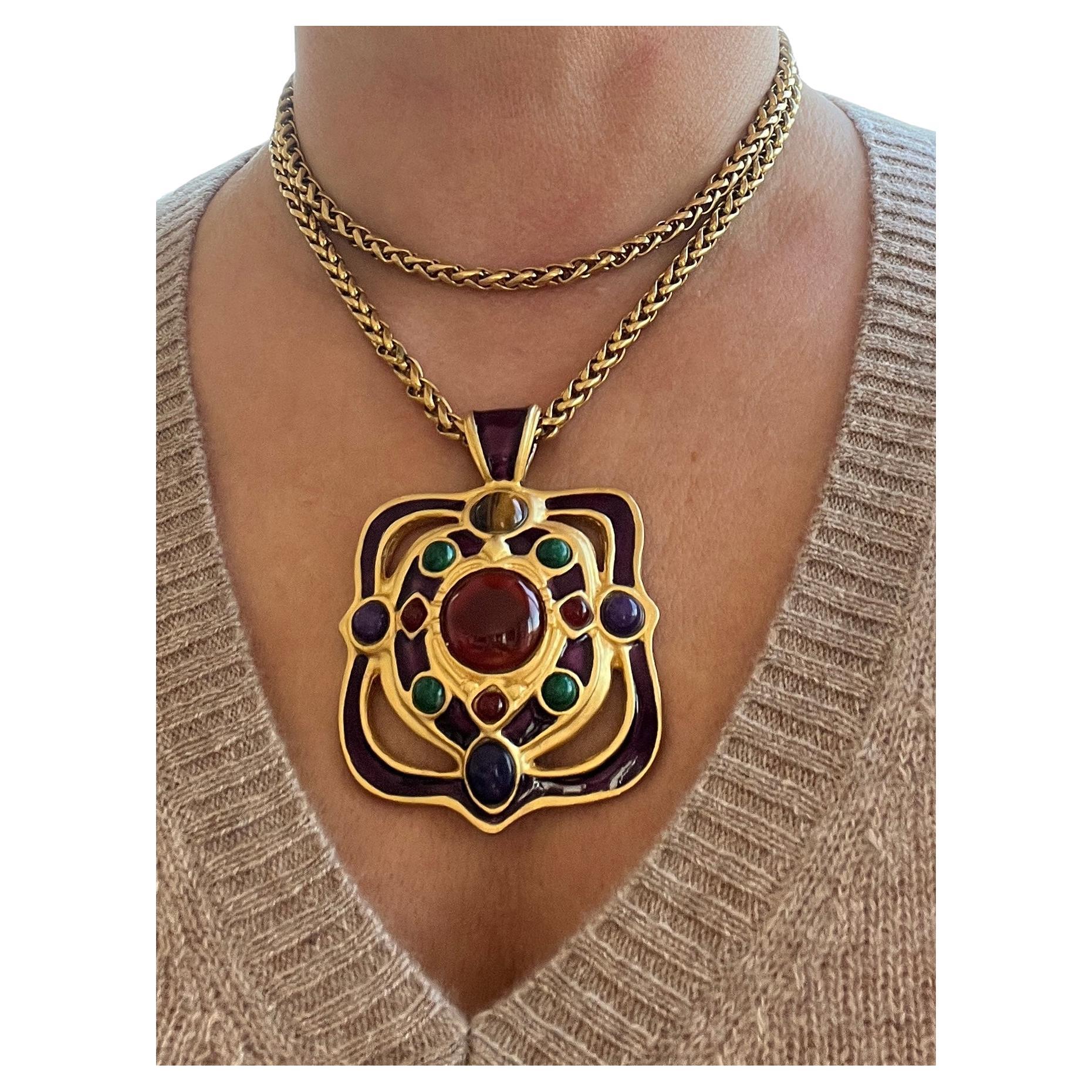 This stunning vintage necklace draws inspiration from Byzantine artistry and runway haute couture, featuring a bold carnelian cabochon at its center, surrounded by three smaller carnelians. The pendant is further enhanced with four vibrant malachite