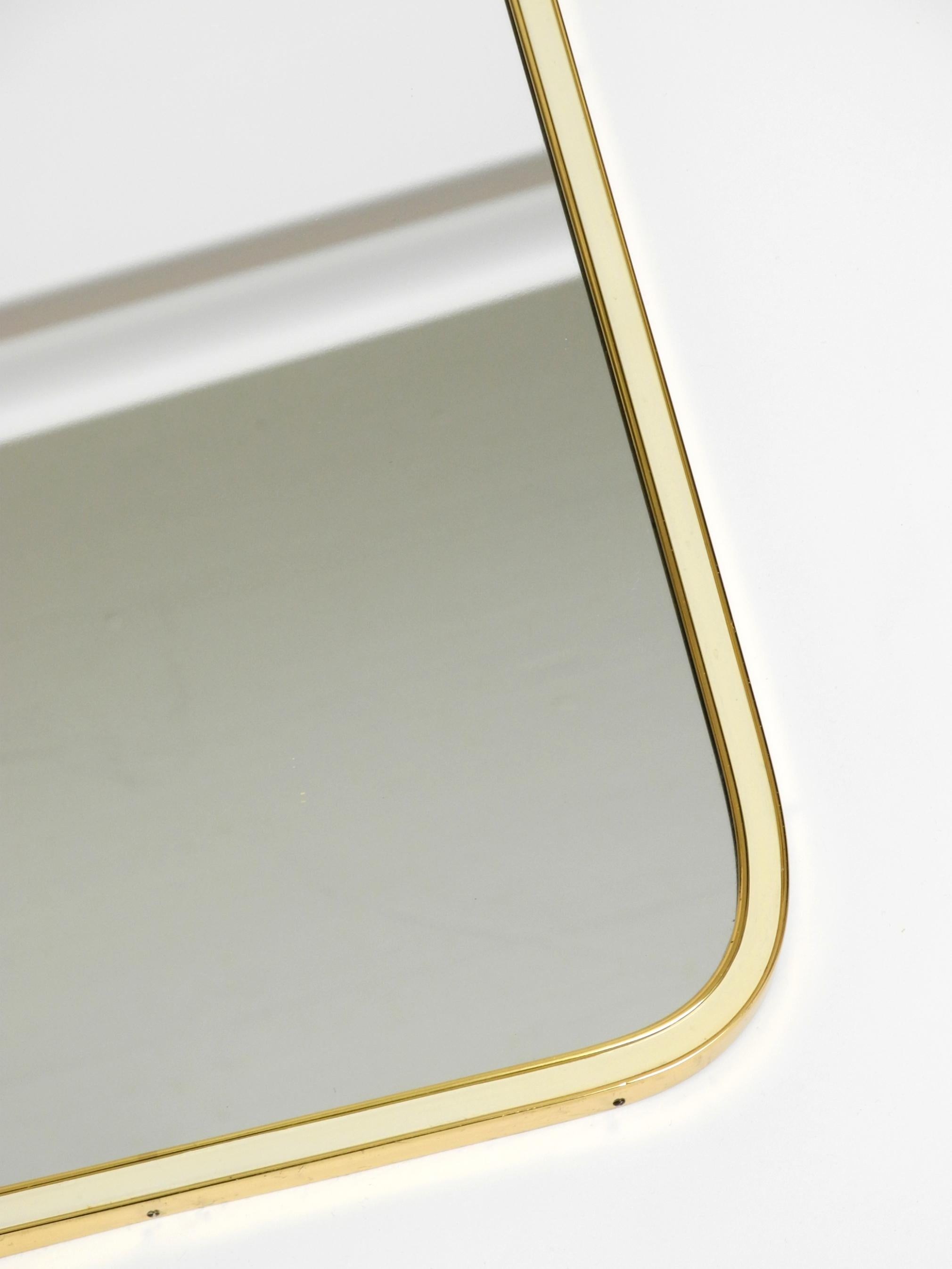 Large heavy long Mid Century brass wall mirror by Münchner Zierspiegel For Sale 6