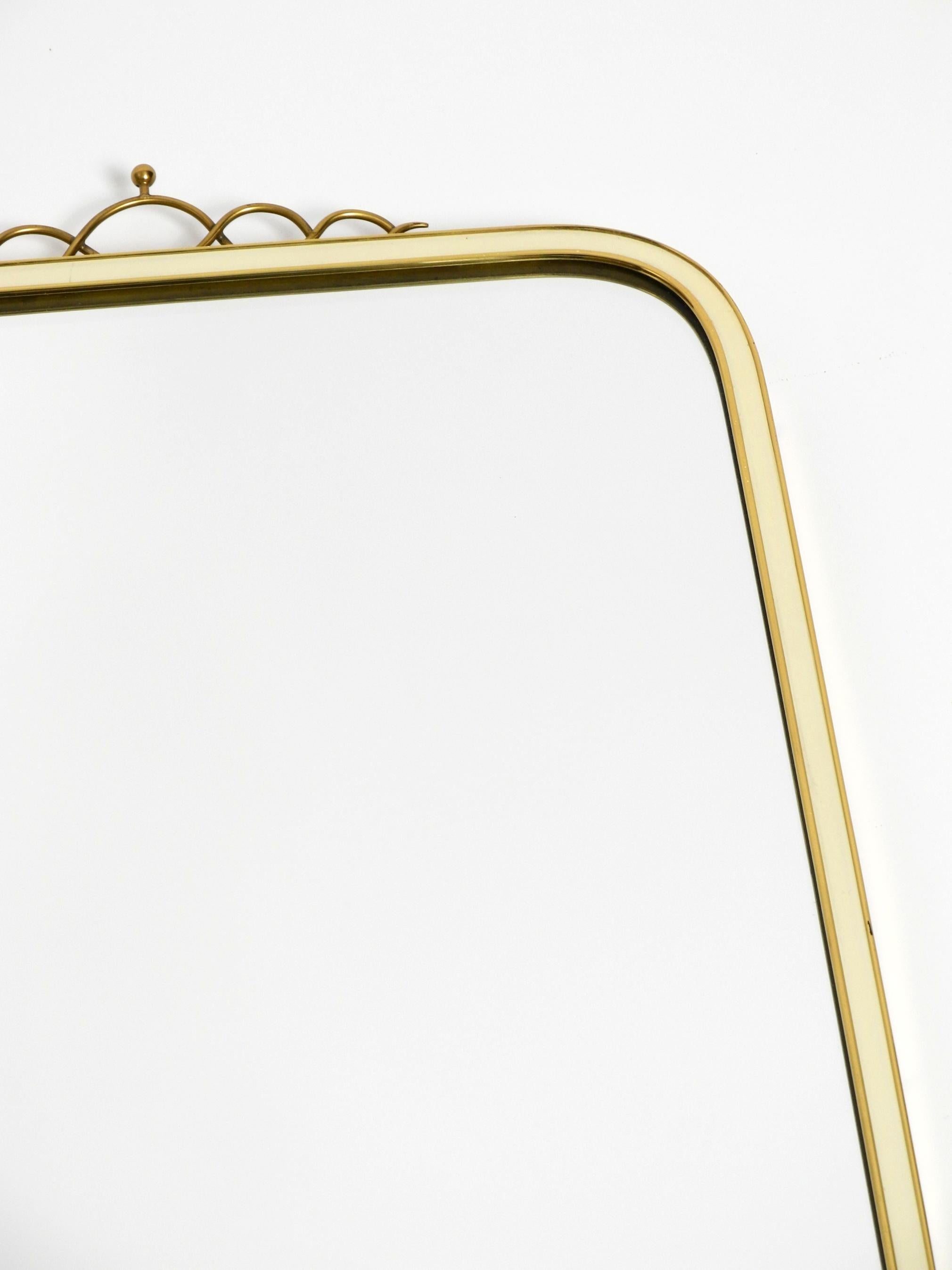 Large heavy long Mid Century brass wall mirror by Münchner Zierspiegel For Sale 9