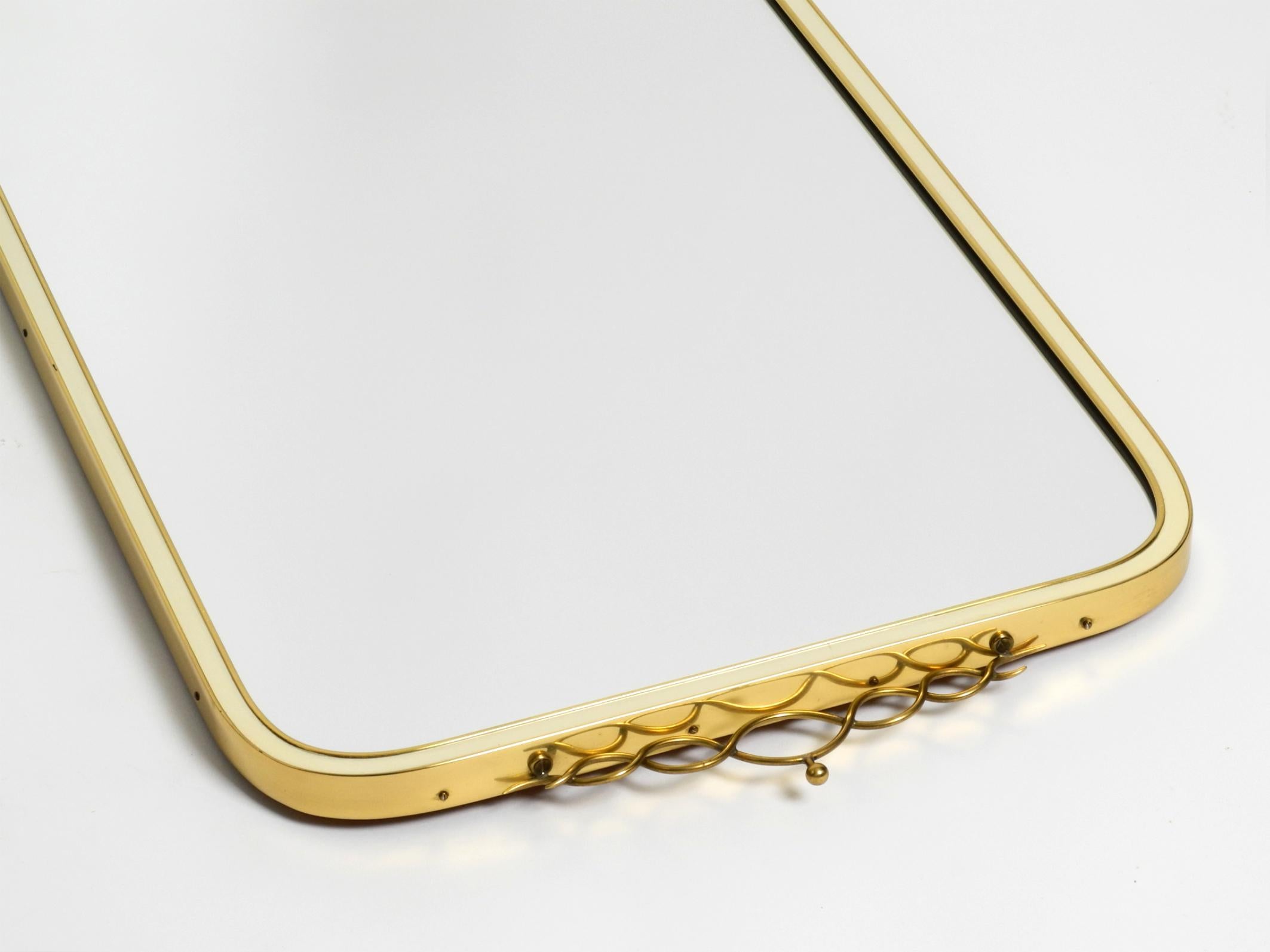 Large heavy long Mid Century brass wall mirror by Münchner Zierspiegel For Sale 11