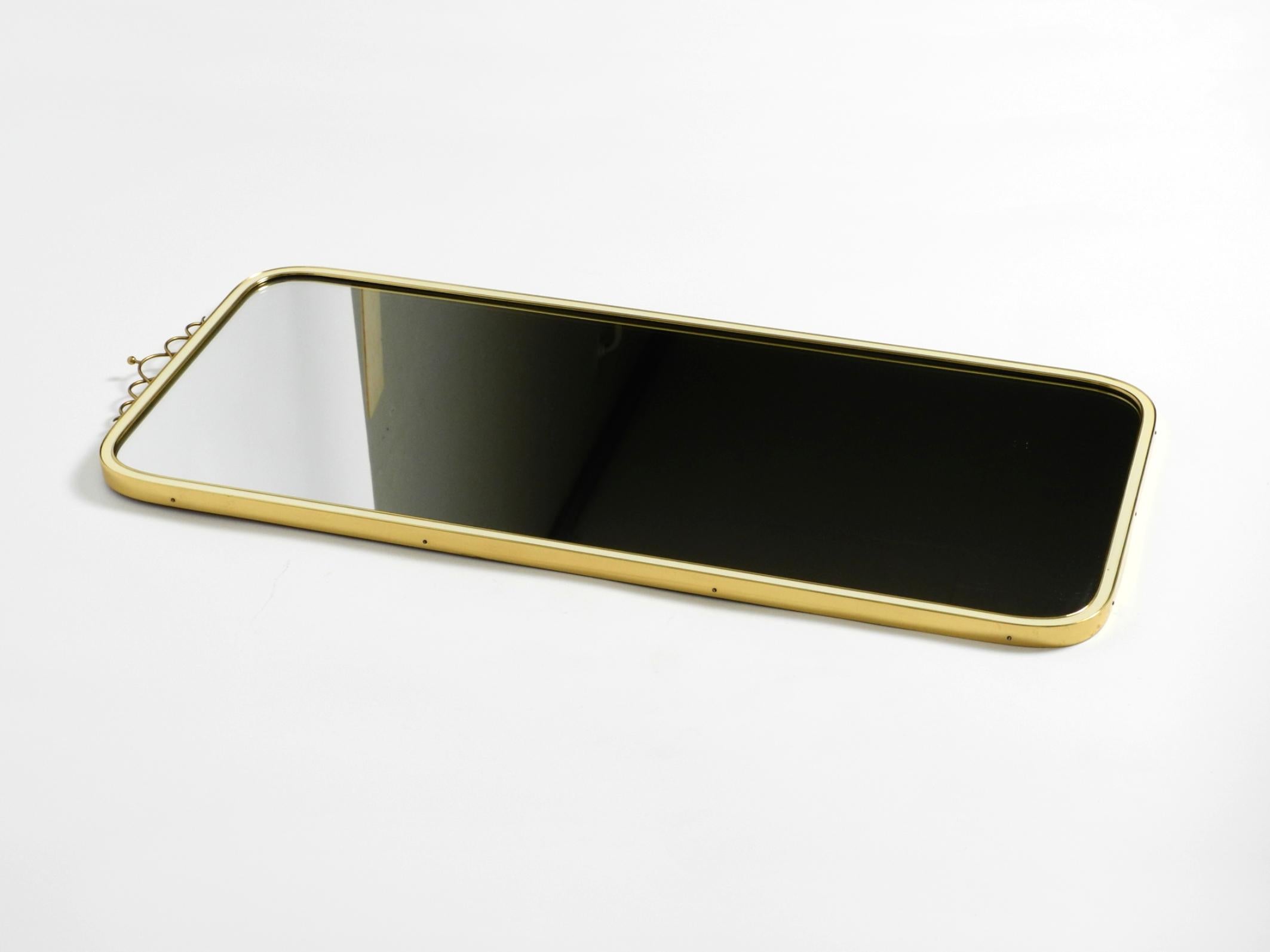 Large heavy long Mid Century brass wall mirror by Münchner Zierspiegel For Sale 13