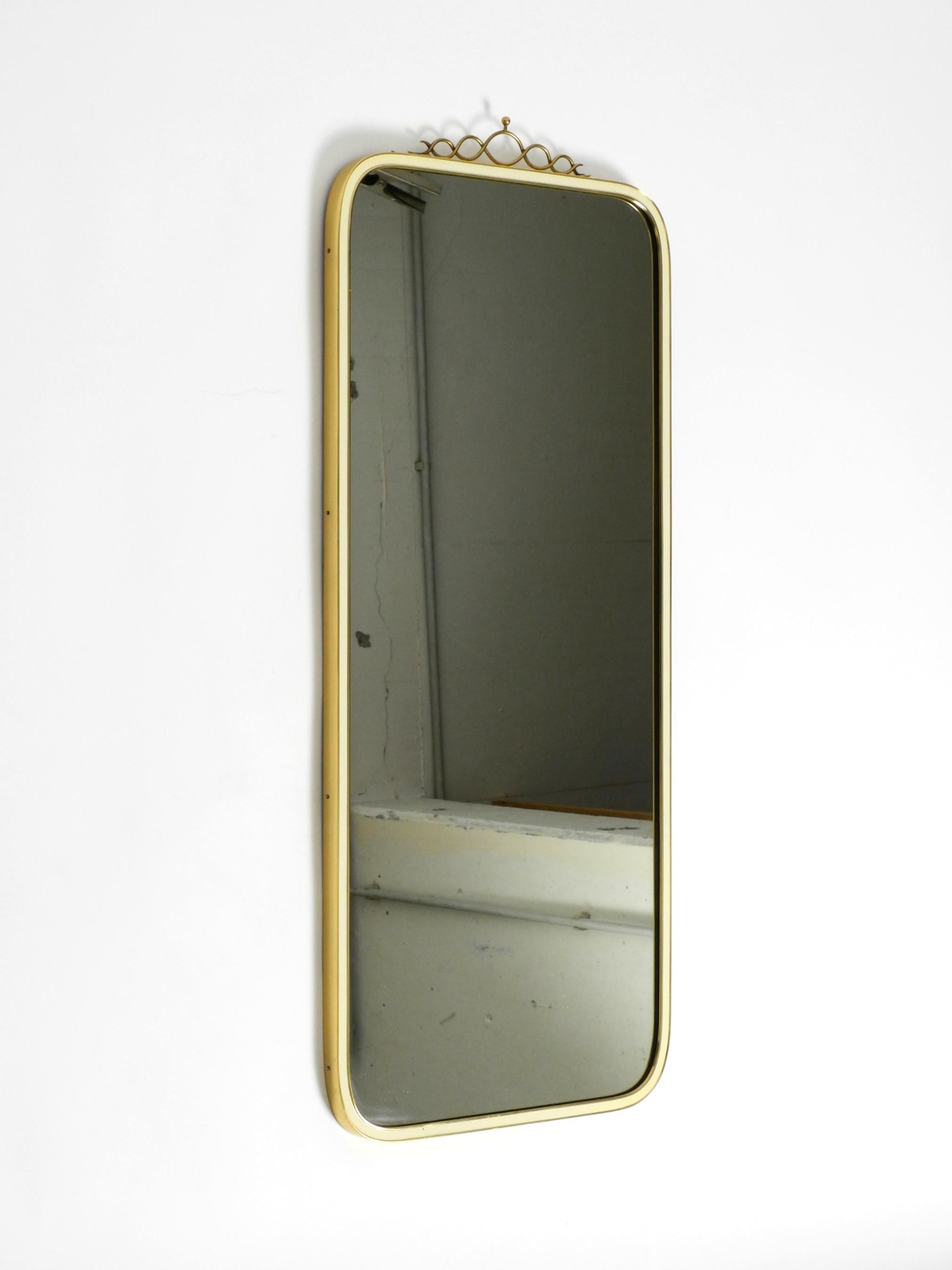 German Large heavy long Mid Century brass wall mirror by Münchner Zierspiegel For Sale