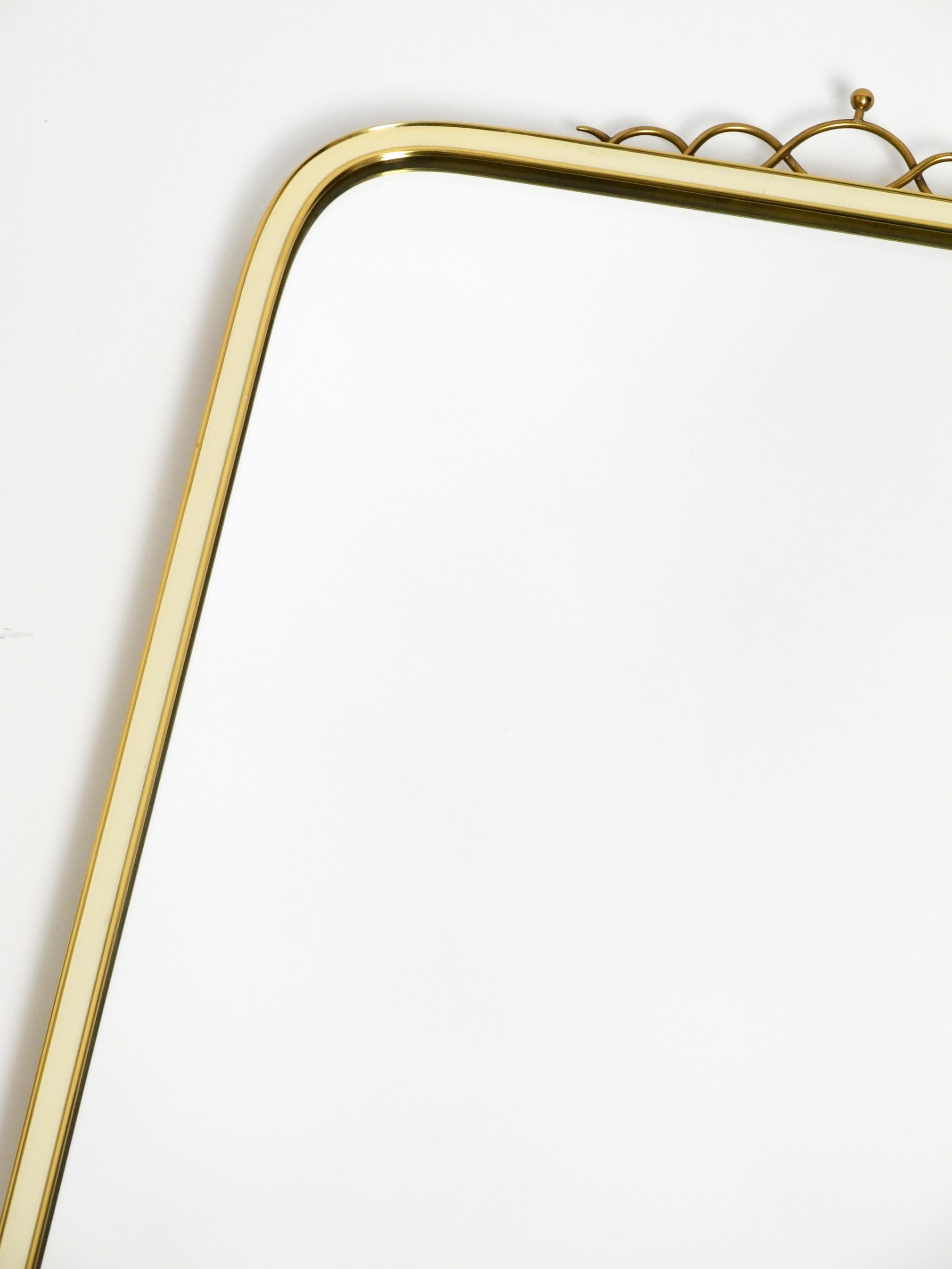 Brass Large heavy long Mid Century brass wall mirror by Münchner Zierspiegel For Sale