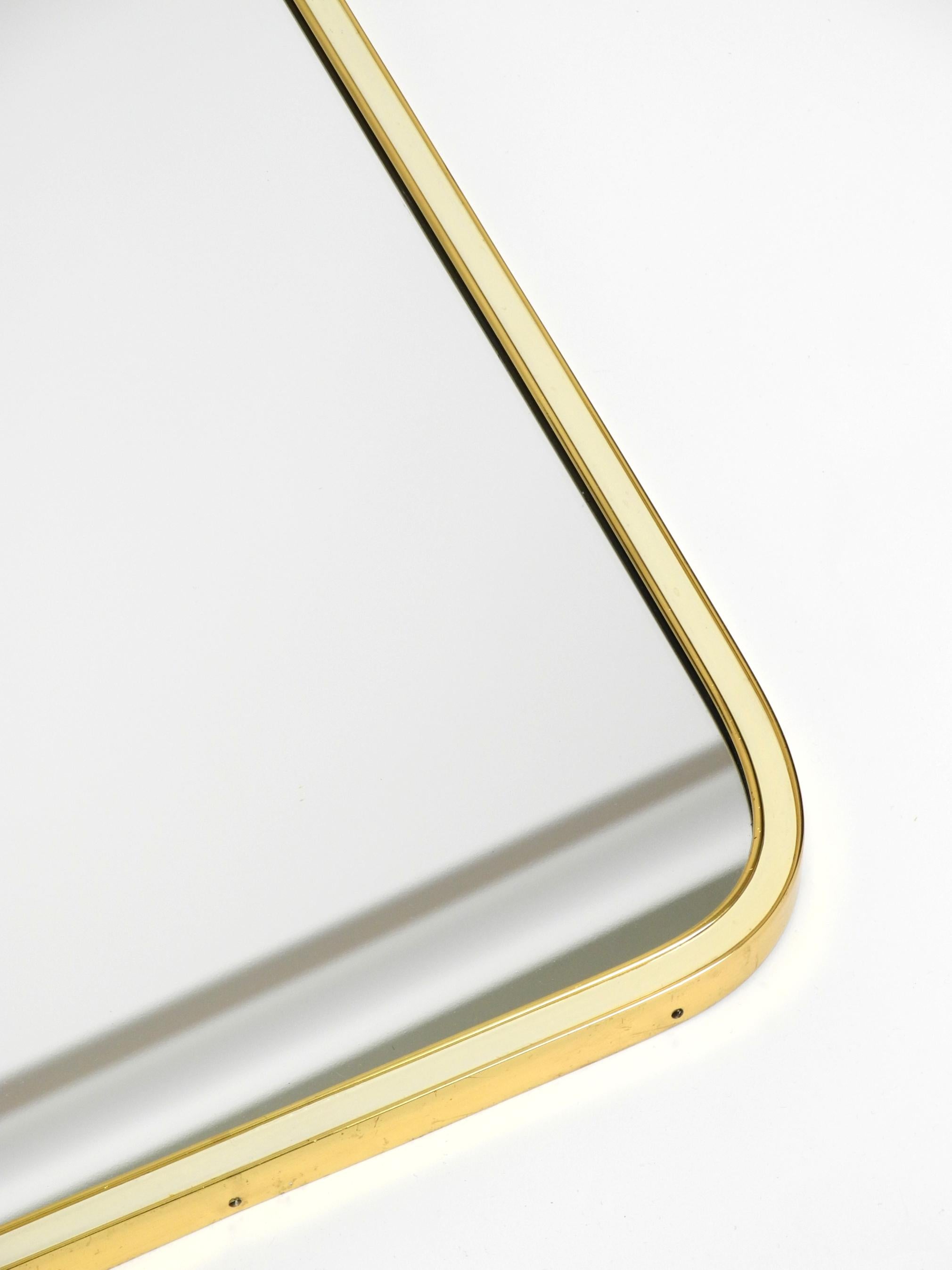 Large heavy long Mid Century brass wall mirror by Münchner Zierspiegel For Sale 1