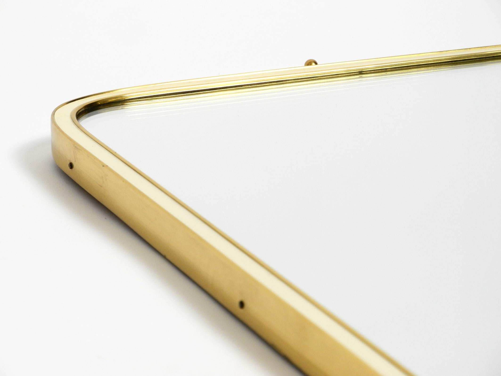 Large heavy long Mid Century brass wall mirror by Münchner Zierspiegel For Sale 2