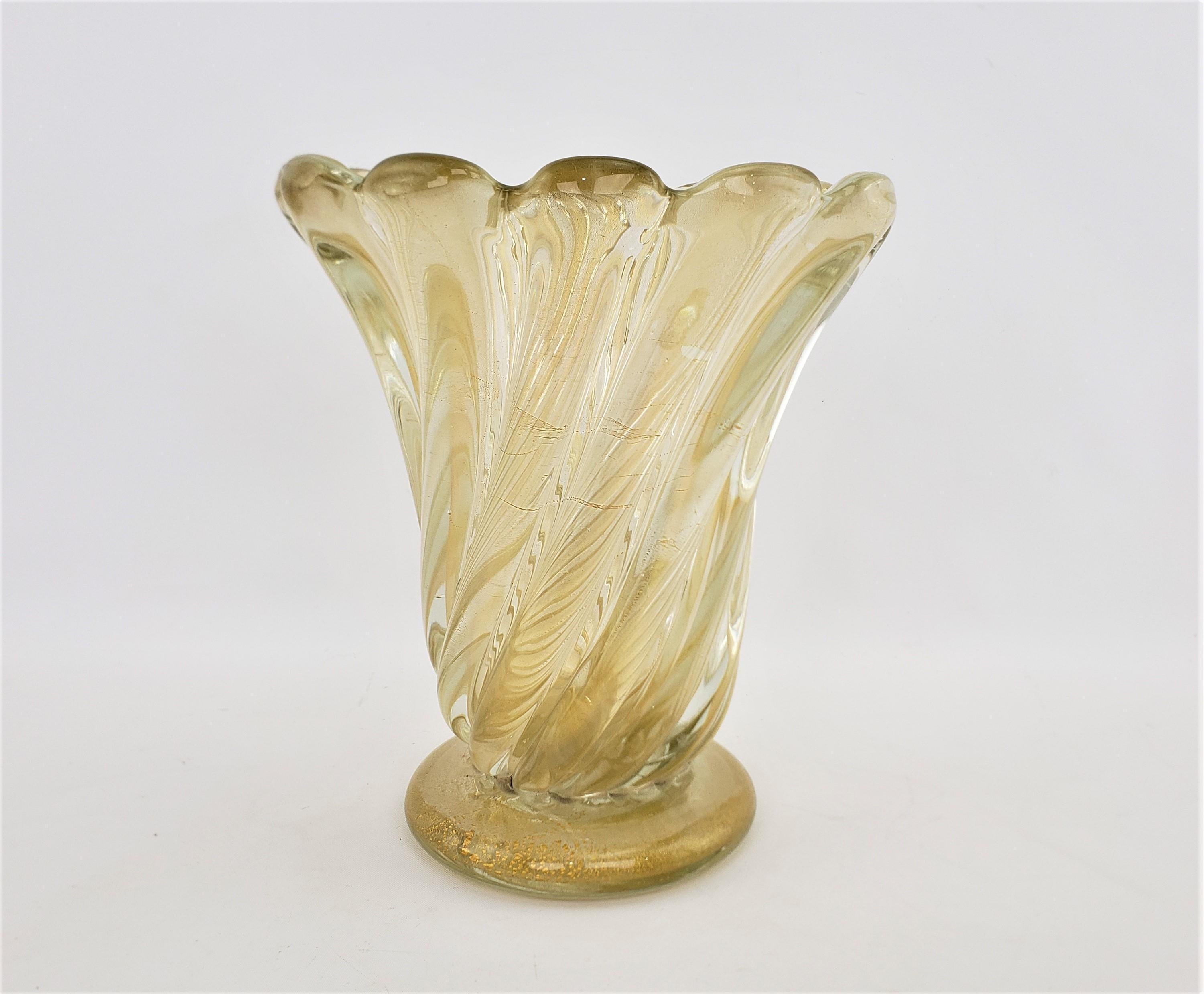 This large and substantial art glass vase is unsigned, but presumed to have been done in Murano Italy in approximately 1965 in a Barovier Mid-Century Modern style. The vase is done with a very thick clear glass that has a ribbed swirl from the base