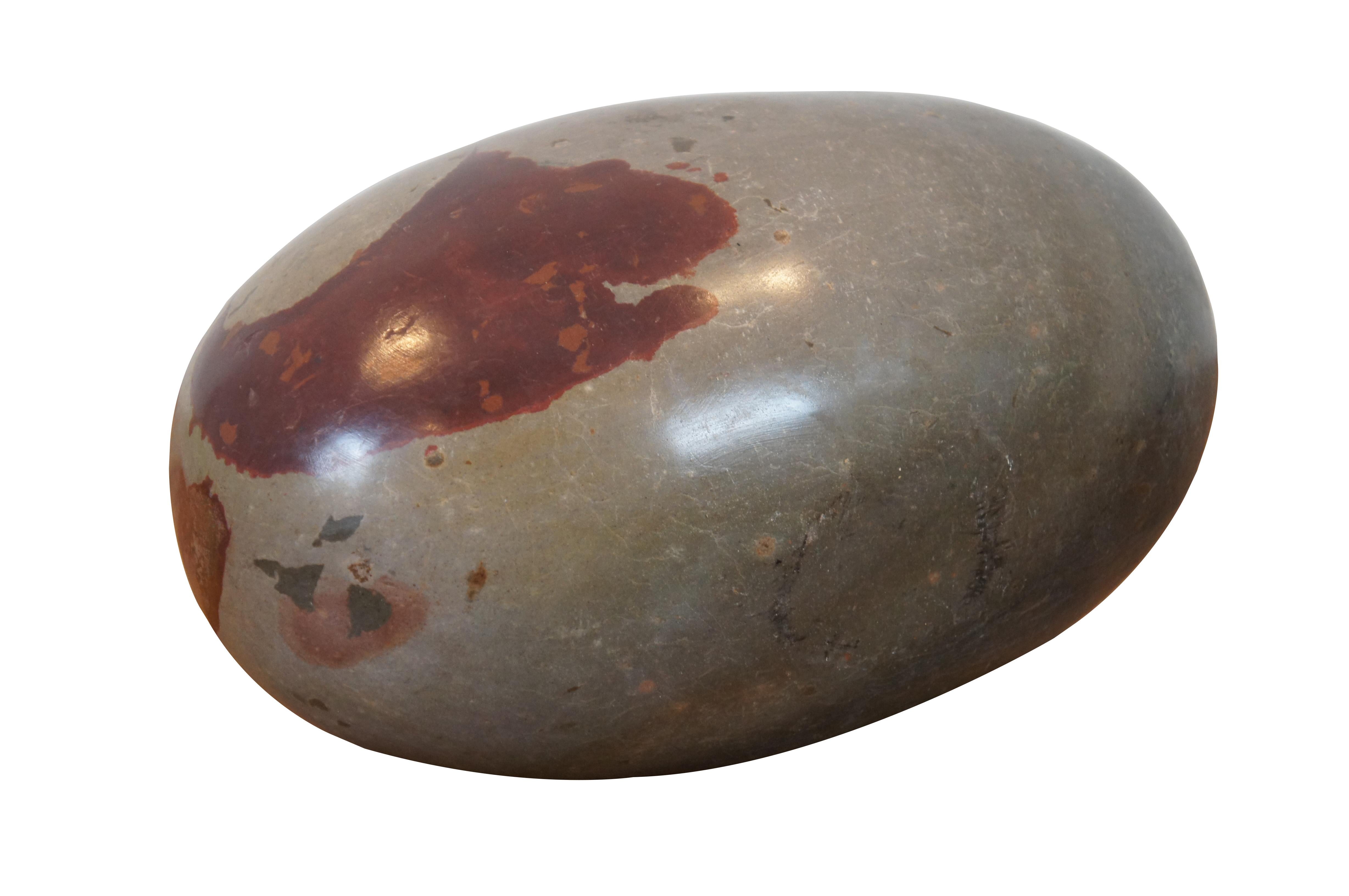 Shiva Lingam is a crypto-crystalline member of the Quartz family. This heavy stone is found in only one of seven sacred Indian rivers. Villagers visit the Narmada River in Onkar Mandhata and polish these river rocks to better define their famed