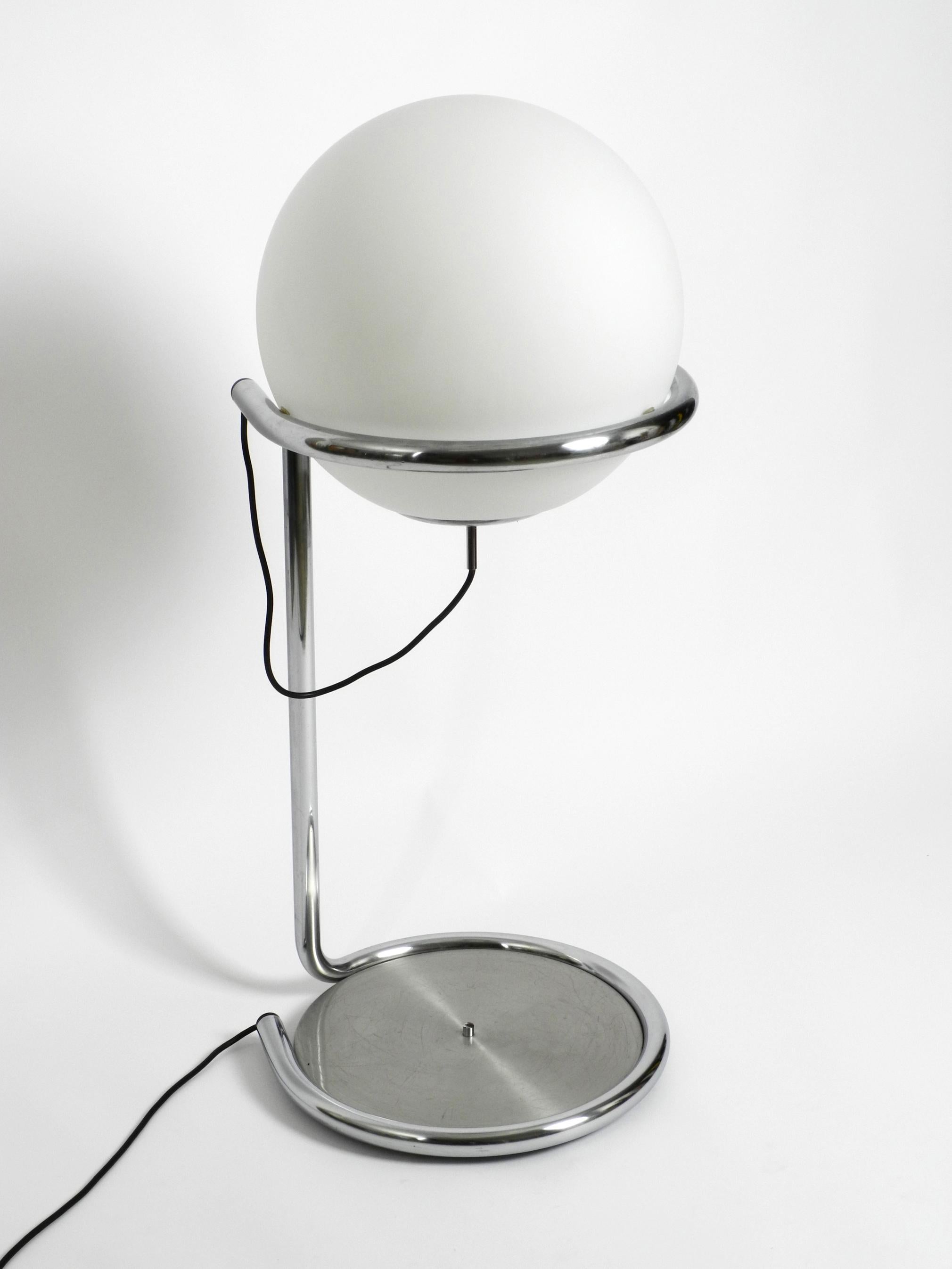 Rare beautiful large heavy chrome-plated tubular steel floor 
lamp with large glass ball shade. Great Space Age design from the 1960s.
Very high quality. Manufacturer unknown.
The entire frame consists of a curved 3 cm thick chromed metal