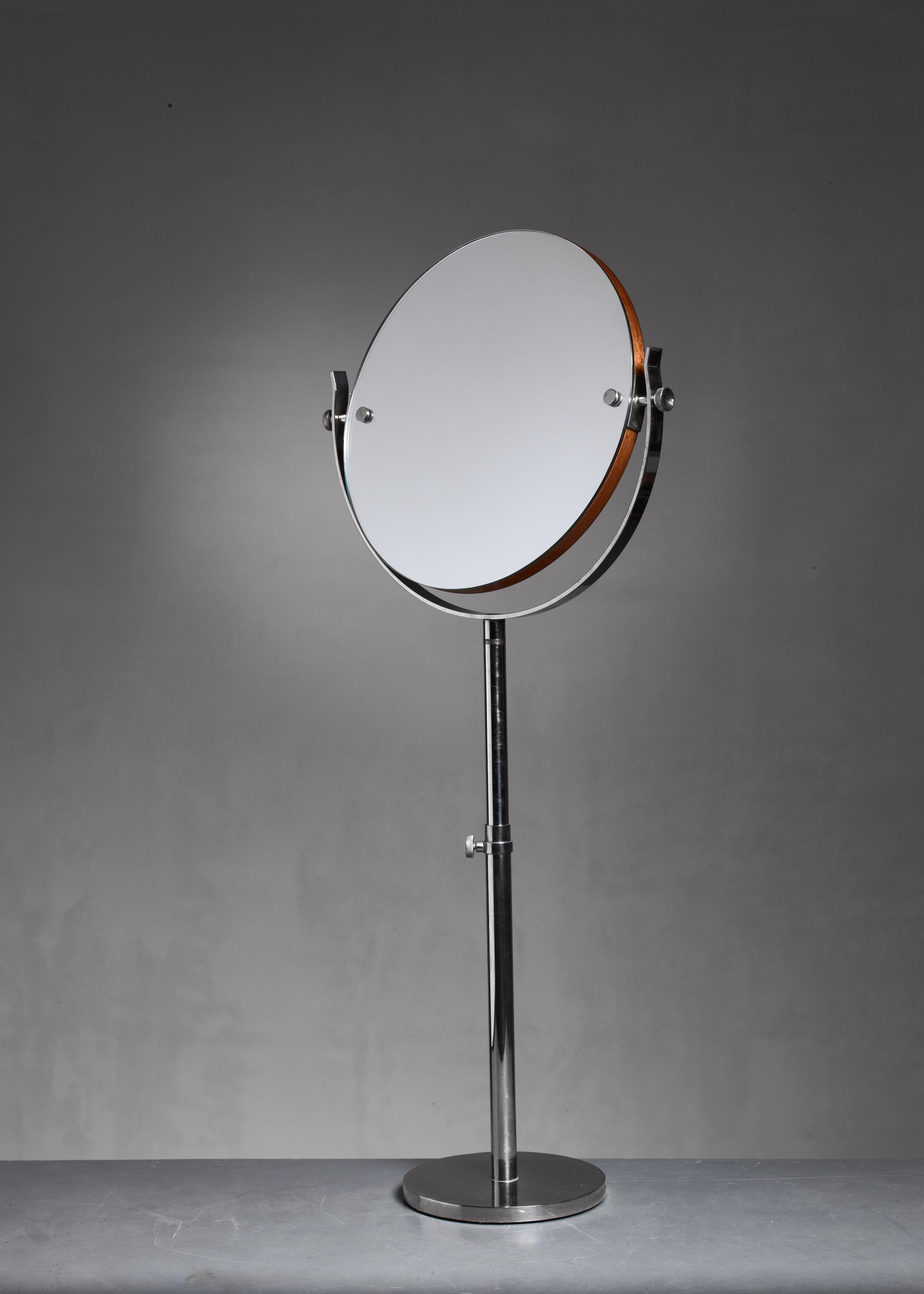 A large, height-adjustable (75-95 cm) vanity or shaving mirror made of nickel and wood. The diameter of the mirror itself is 36 cm (14