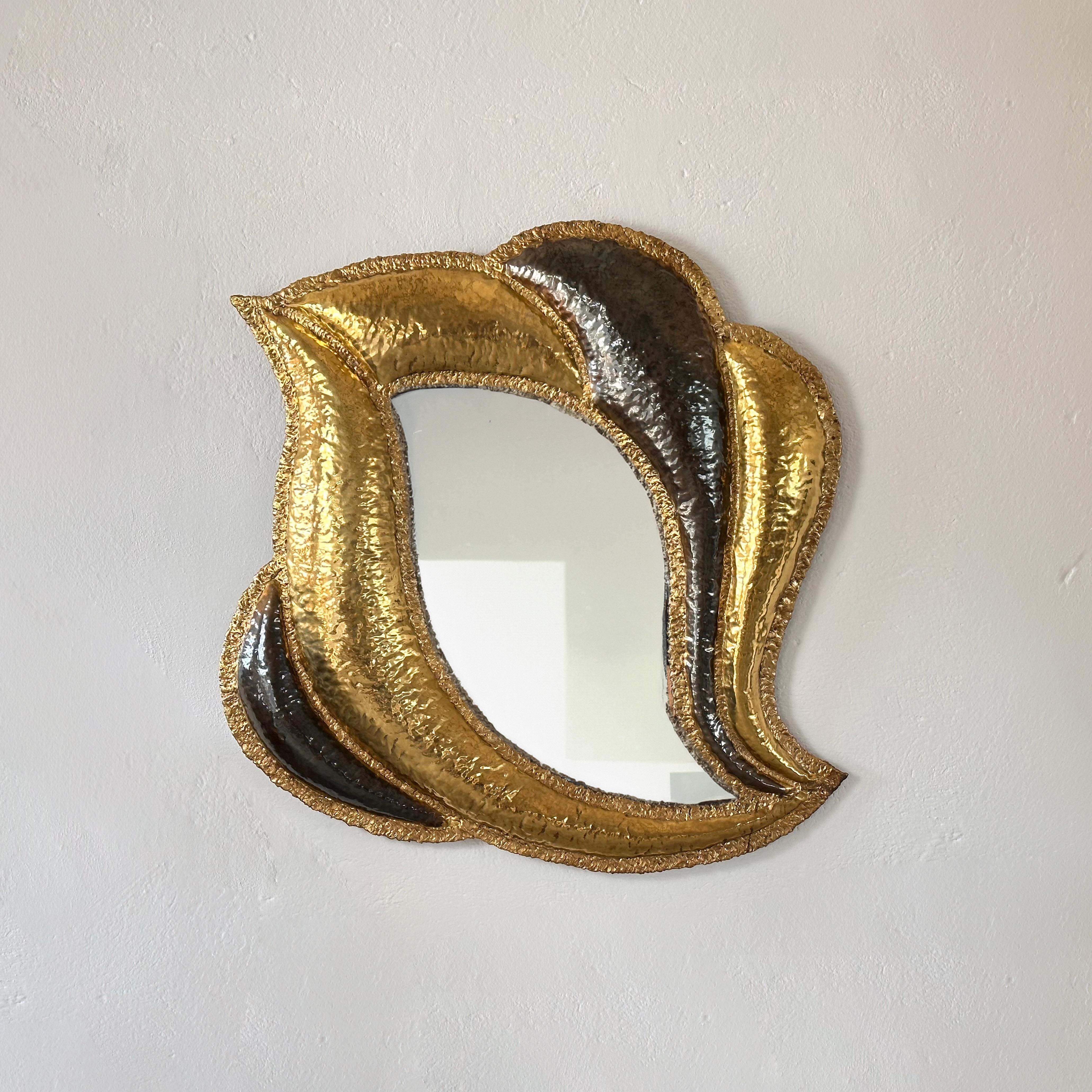 Elevate your interior with this stunning large hand-crafted brass mirror, designed by Henri Fernandez for Maison Honoré Paris in the 1970s and signed by the artist. This exceptional piece exudes elegance and sophistication, adding a touch of French