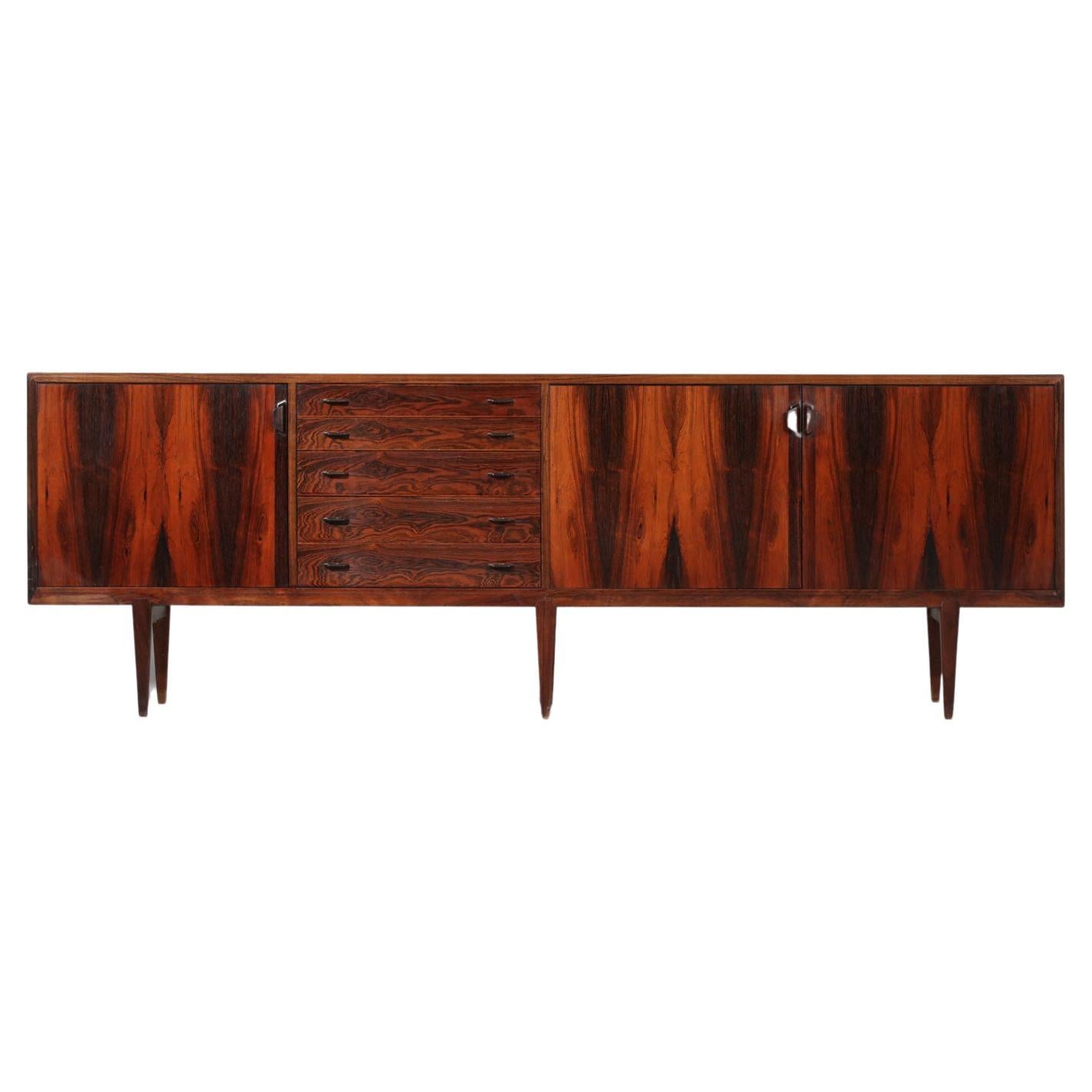 Large Scandinavian sideboard by Danish designer Henry Rosengren Hansen from the 60's for Brande Mobelindustri. Structure in solid and veneered Rio rosewood. The enfilade consists of three swinging doors with four height adjustable interior shelves