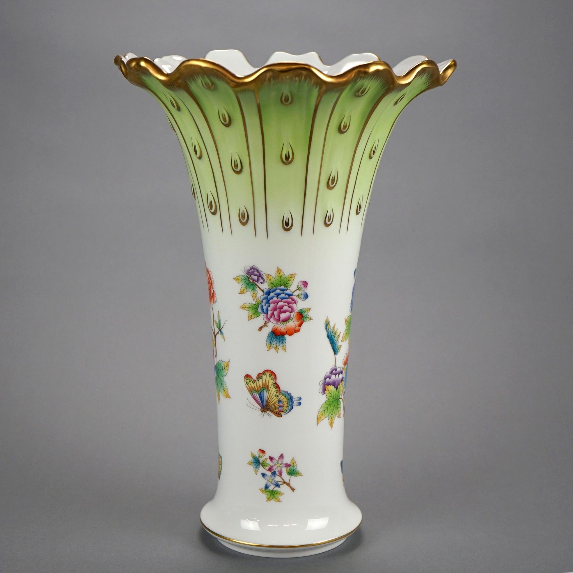 A large vase by Herend offers porcelain construction ;in flared form having ruffled rim and painted garden flowers with butterfly, gilt highlights throughout, maker mark on base as photographed, 20th century

Measures- 14.5''H x 9.5''W x 9.5''D.