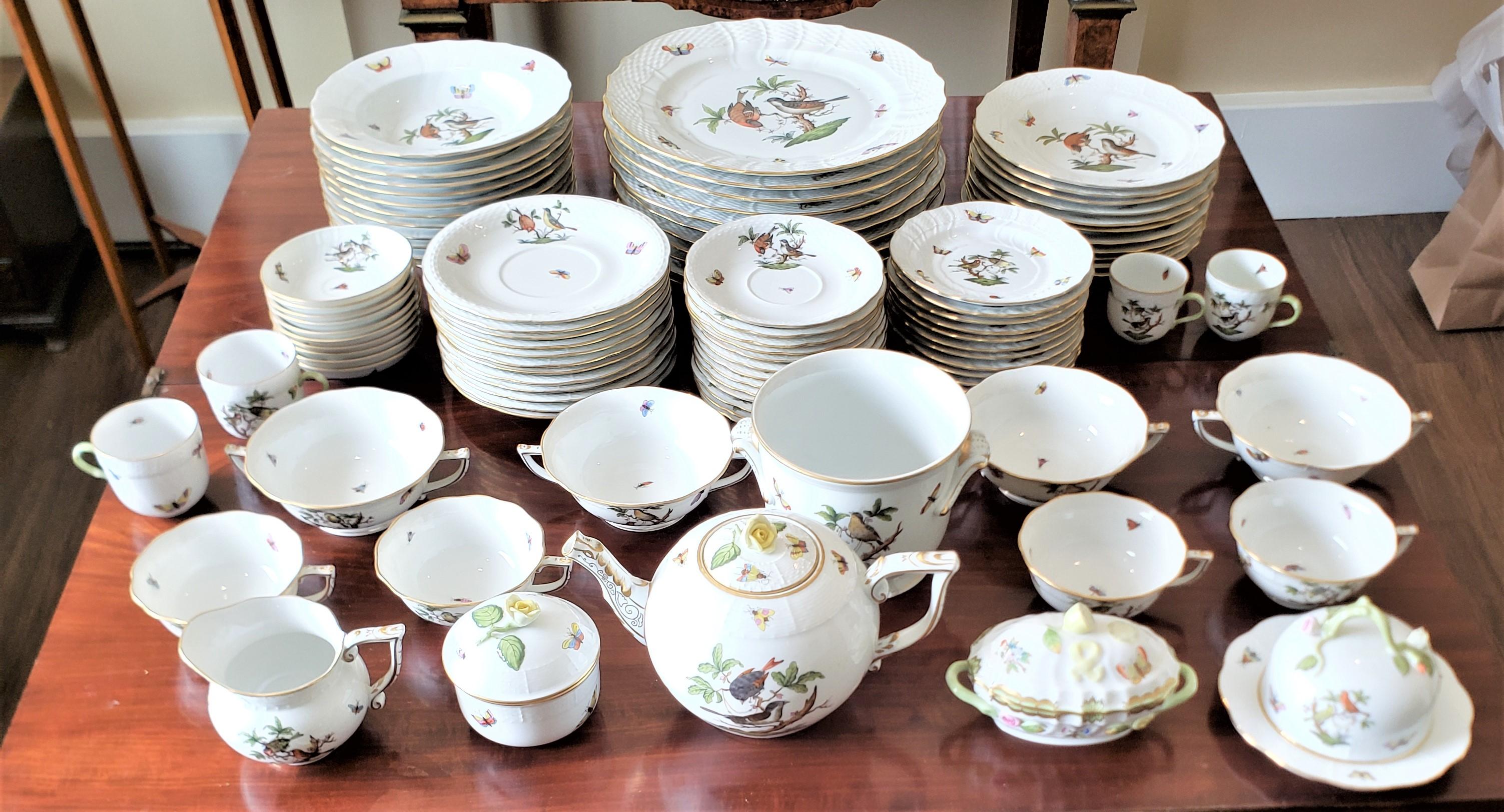 This large dinner service was made by the renowned Herend porcelain manufacturer of Hungary in approximately 1970 in their green Rothschild pattern. Each piece is decorated with various hand-painted bugs and butterflies with a central medallion with