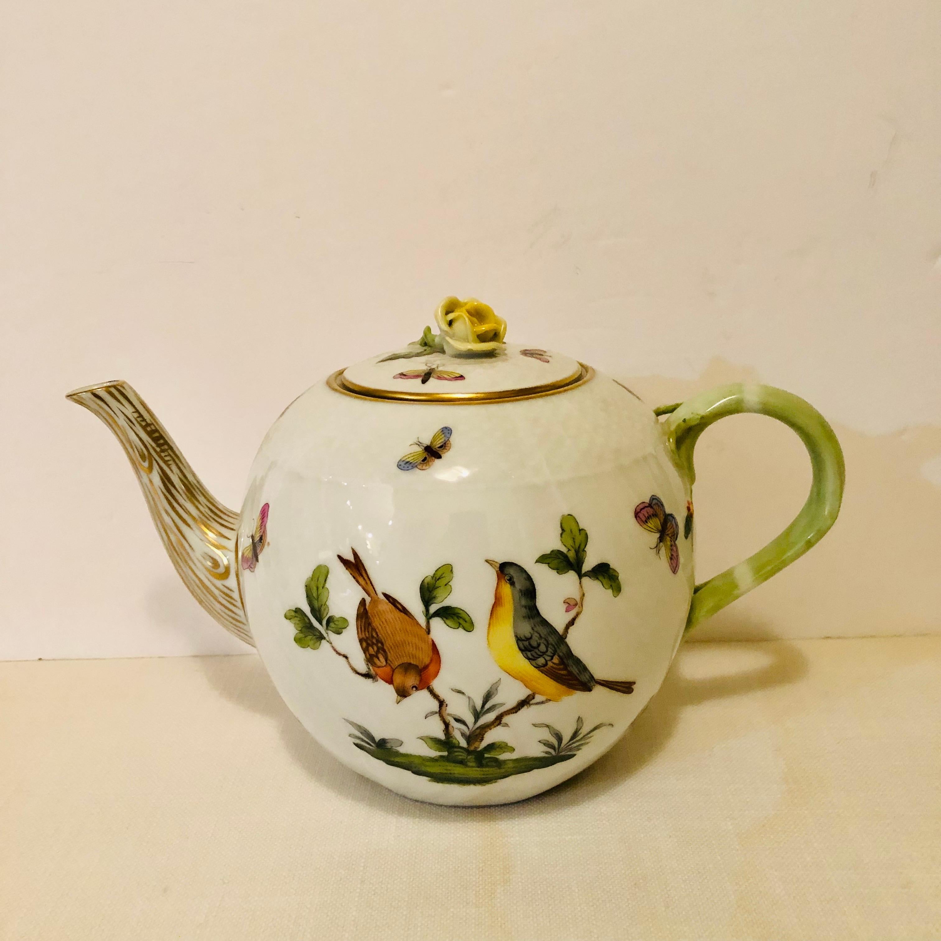 I want to present you with this charming large Herend Rothschild Bird teapot. It is hand painted with two birds on each side with added colorful accents of butterflies and insects on a white background. The lid of the teapot has a raised lovely