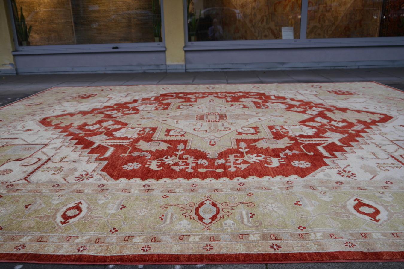 An oversize rug with traditional Heriz design, hand knotted in Afghanistan. The pile is made of high end quality wool, hand spun, hand dyed with all vegetable dyes and knotted by master weavers. The rug is very decorative and has a towards square