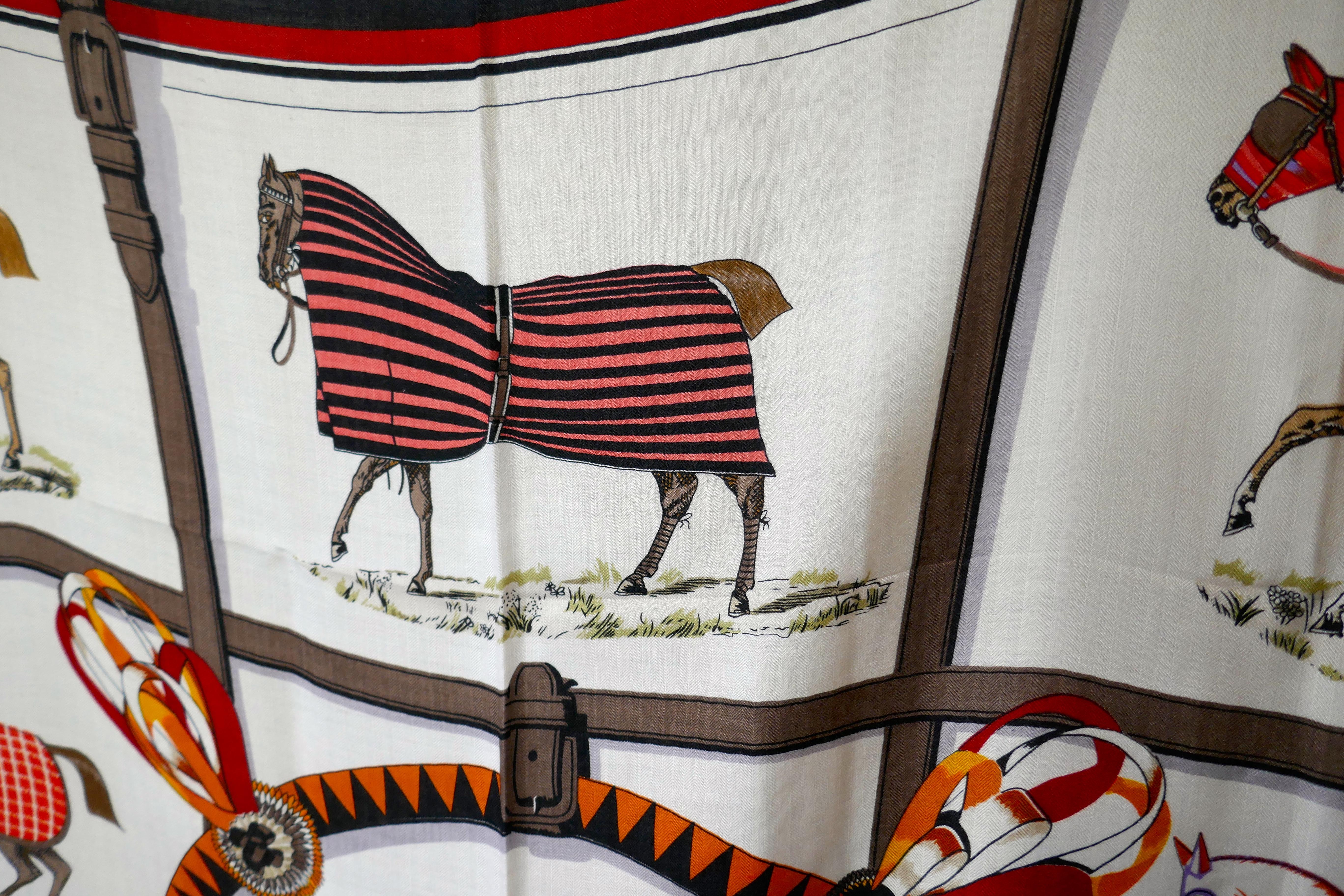 Large Hermes Cashmere Shawl “Couvertures et Tenues de Jour” Design Jacques Eudel 

Very Large, Light and Warm Cashmere and Silk Shawl 
Ecru Shawl showing the Blankets for Horses the designers signature and the Hemes logos worked into the design
The