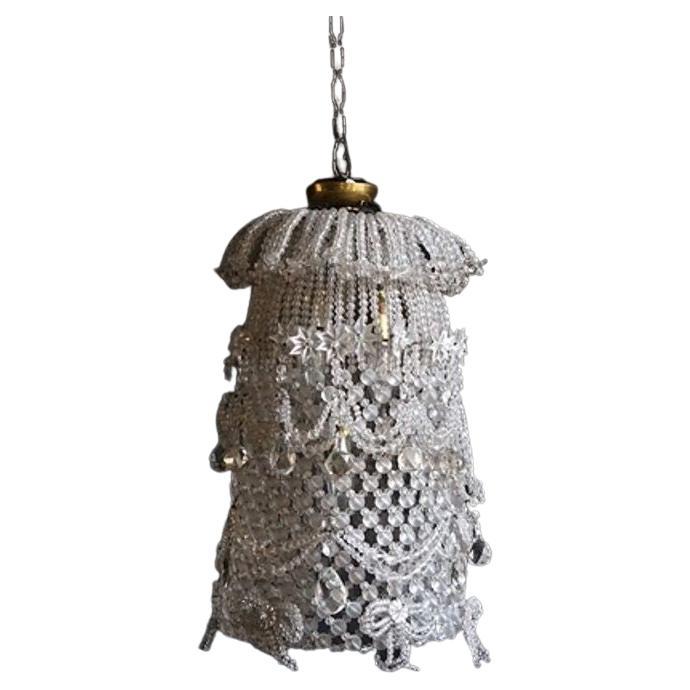 Large Unusual and Decorative Hanging Pendant Light Fitting

Consisting of woven wirework with frosted and cut crystal beadwork with swags, bows and star details.

Five internal light fittings.

Dating from the 1920s-1950s period.

Rewired and safety